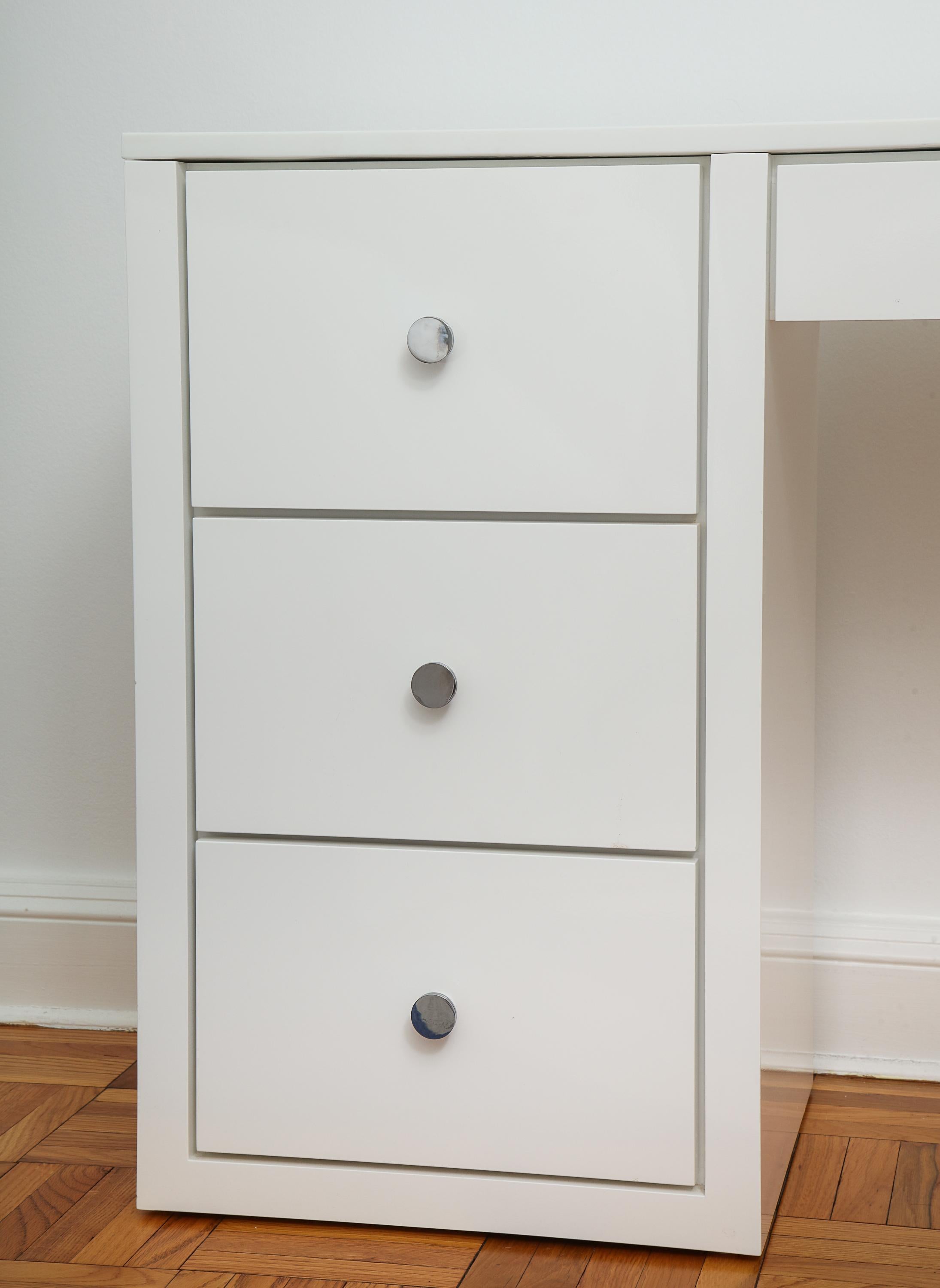 The rectangular top over a long drawer and kneehole with three short drawer set to the left. Simple, sleek design beautifully made.