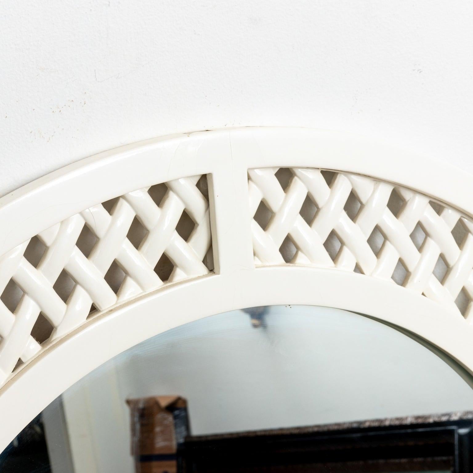 Chic Palm Beach style white lacquer mirror has a graceful arch and open lattice motif. Wear consistent with age.