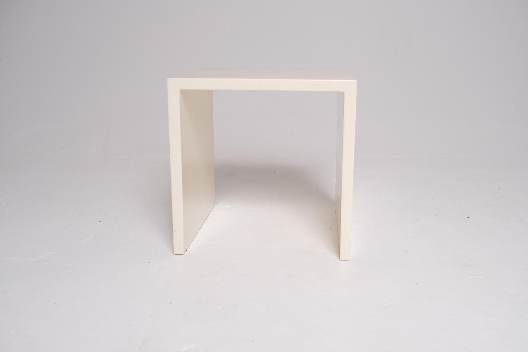 A minimalist design icon by New York-based Property Furniture, the Saddle Side Table is a study in precision and quiet impact. Measuring 15 x 15 x 15 inches, its clean-lined cube form is executed in a high-gloss lacquer finish that adds a sense of