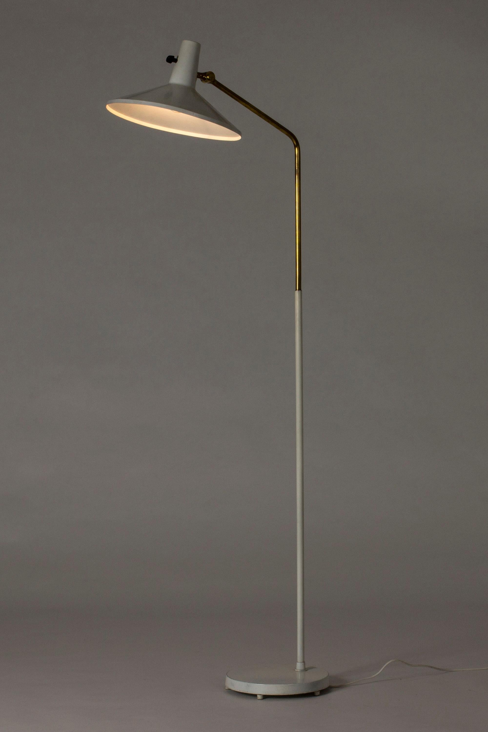 White lacquered metal and brass floor lamp with an edgy silhouette by Bertil Brisborg, designed for the lighting department at NK department store.