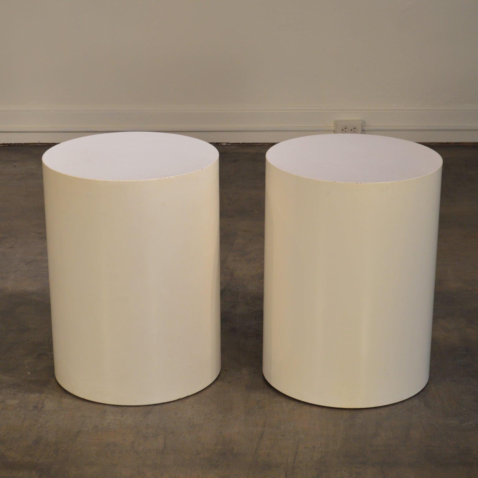 A pair of tall white lacquered drum tables by Paul Mayen for Habitat. A signature design made recognizable by Terrance Conran's 'House' Books of the 1970's and 80's. This simple and substantial design lends itself to a number of settings from