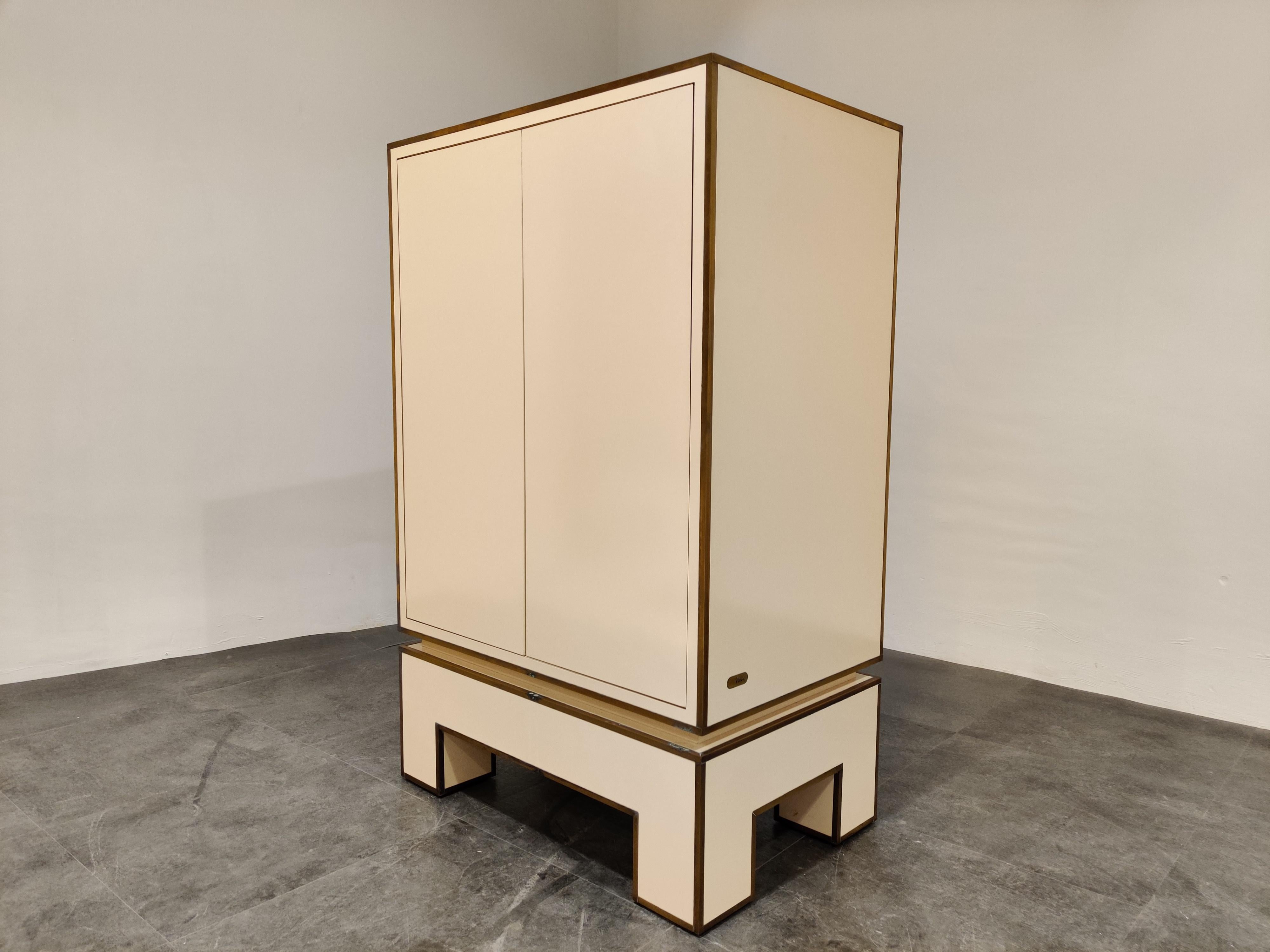 Midcentury cabinet signed by Alain Delon in white lacquer and brass.

This exquisite cabinet is pure quality, with a combination of good materials and the right patina it is a great add-on for any room.

Good condition

1970s,