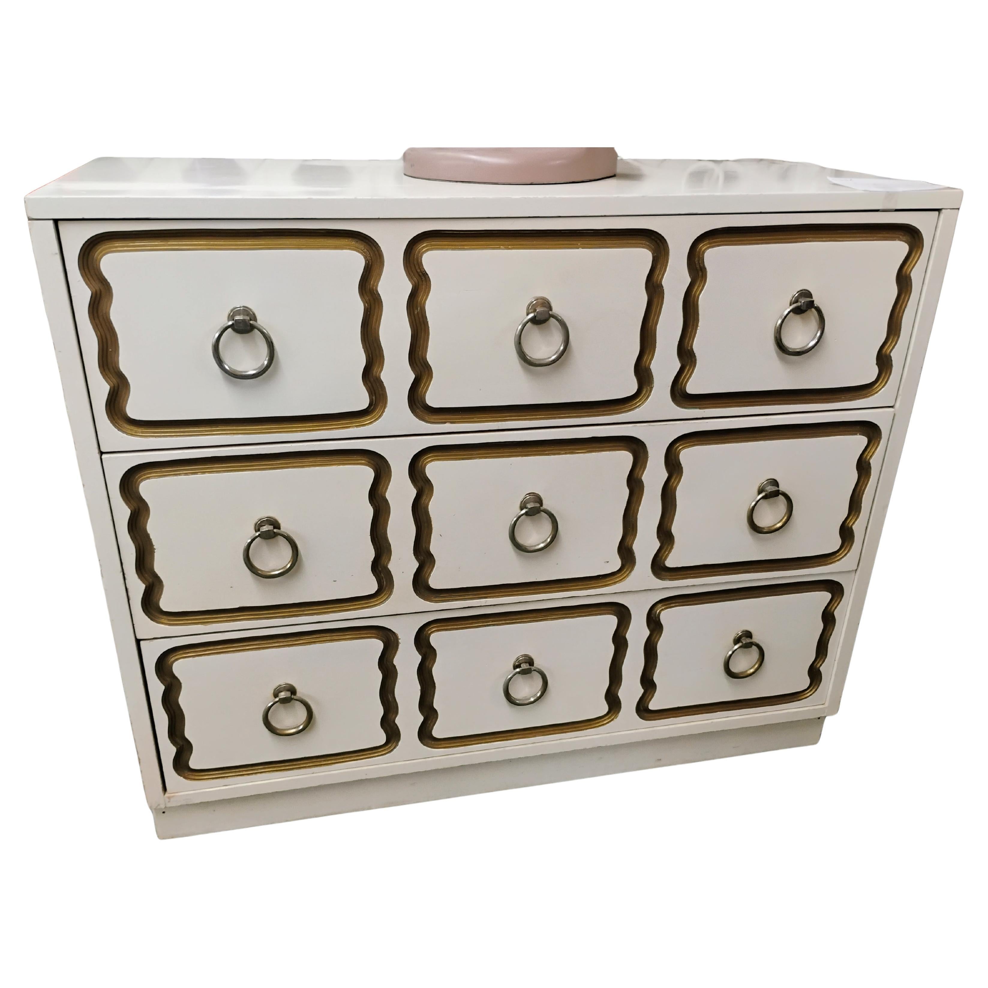 This white lacquered commode is made in the style of the Dorothy Draper 