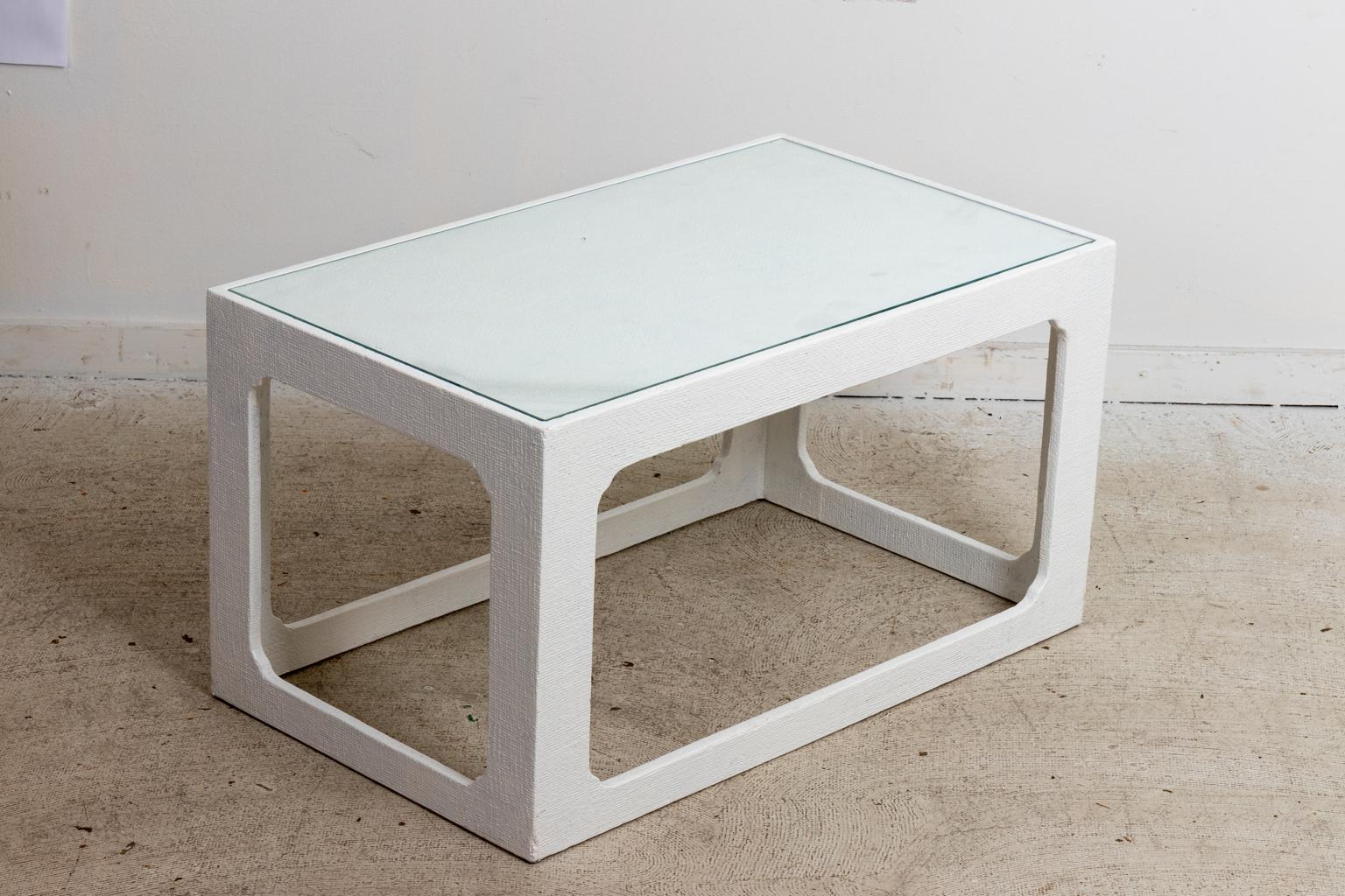 Circa 1970s Mid-Century Modern style white lacquered grass cloth petite low table with set in glass top. Made in the United States. Please note of wear consistent with age. The white lacquer is a latter addition with minor chips to a few corners and