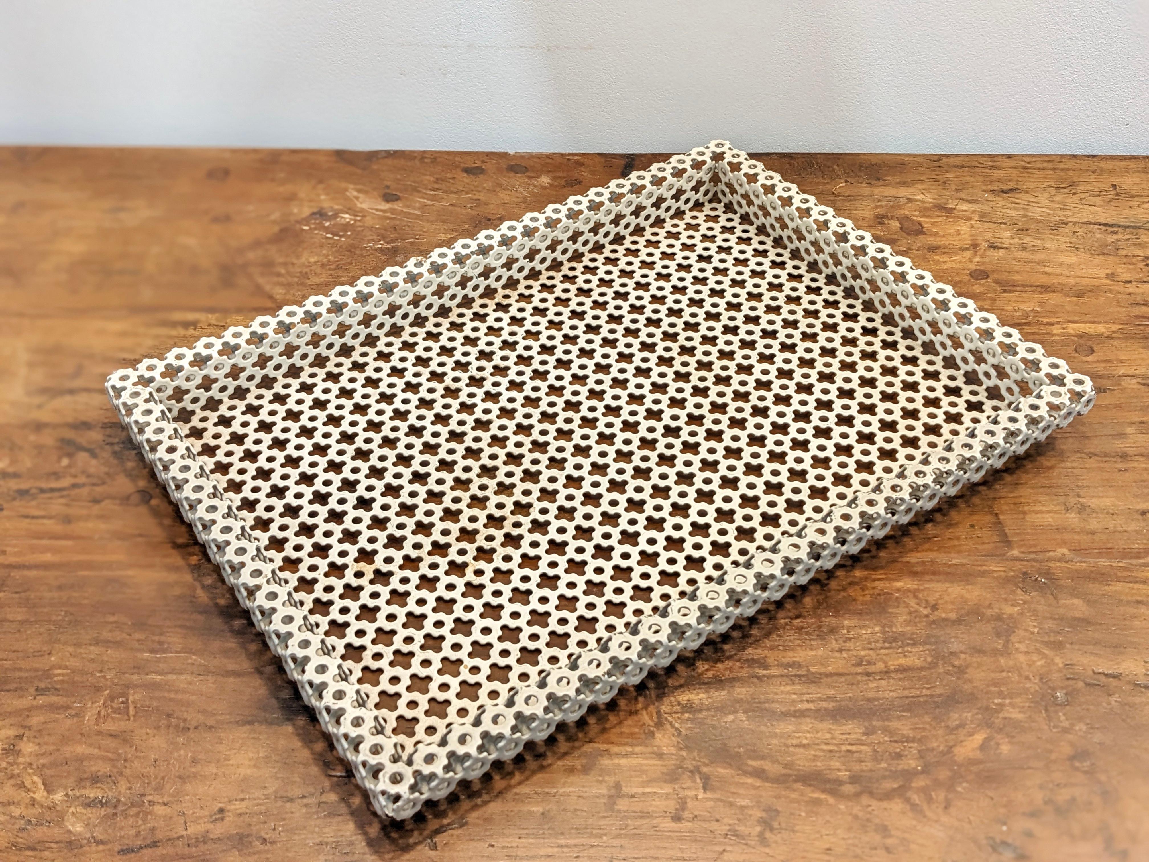 White lacquered metal tray Mathieu Mategot 
circa 1950
Rectangular structure in white lacquered perforated sheet metal. 
Good condition. Traces of wear due to age and use. Some missing lacquer and traces of oxidation (see pictures).
Dimensions :