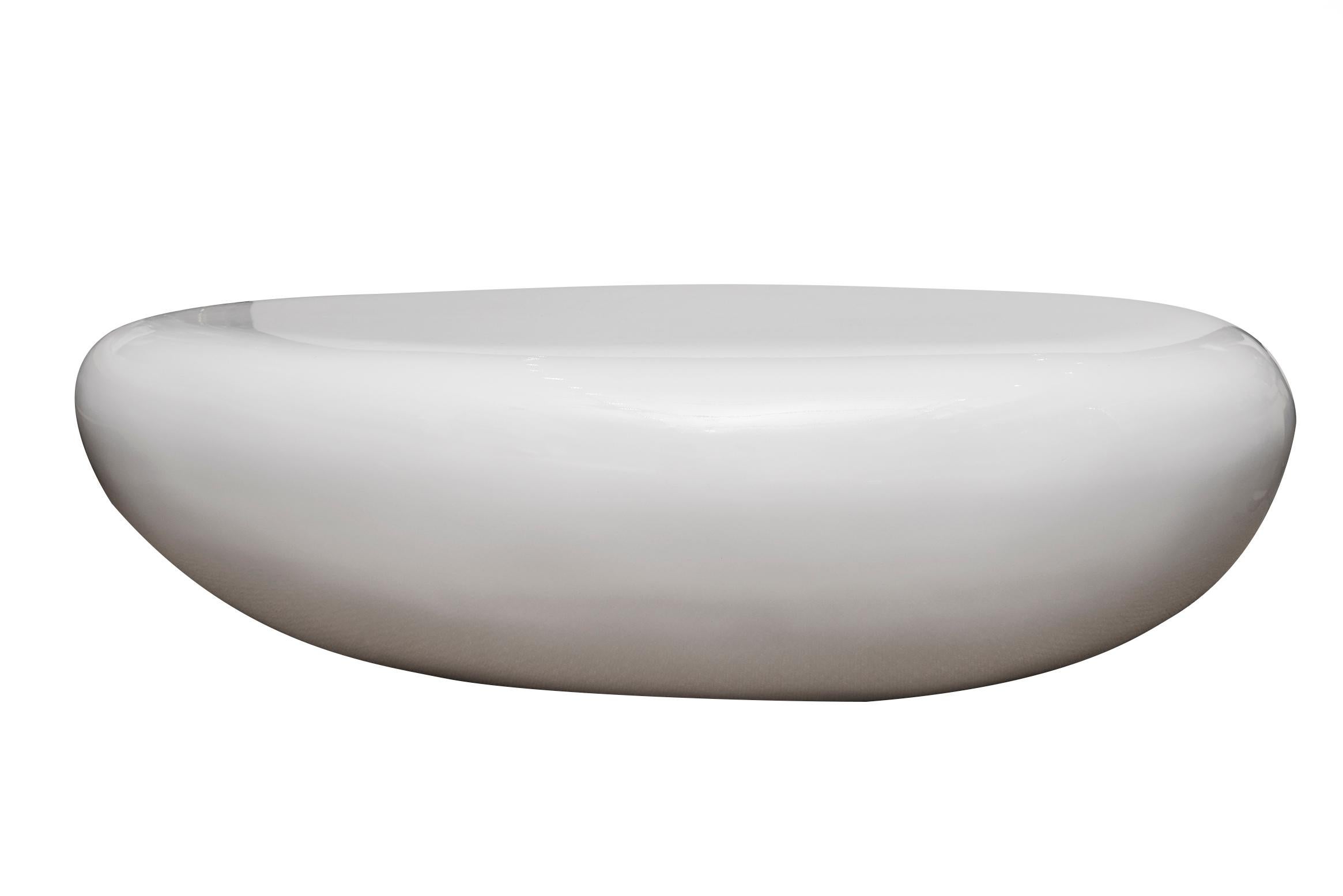 This wonderful sculptural resin cocktail table is in the shape of an egg or bean. From the 80's. It was just repainted with white lacquer automobile paint but it has bubbles on top because it did not dry properly. The restorer who did this is now