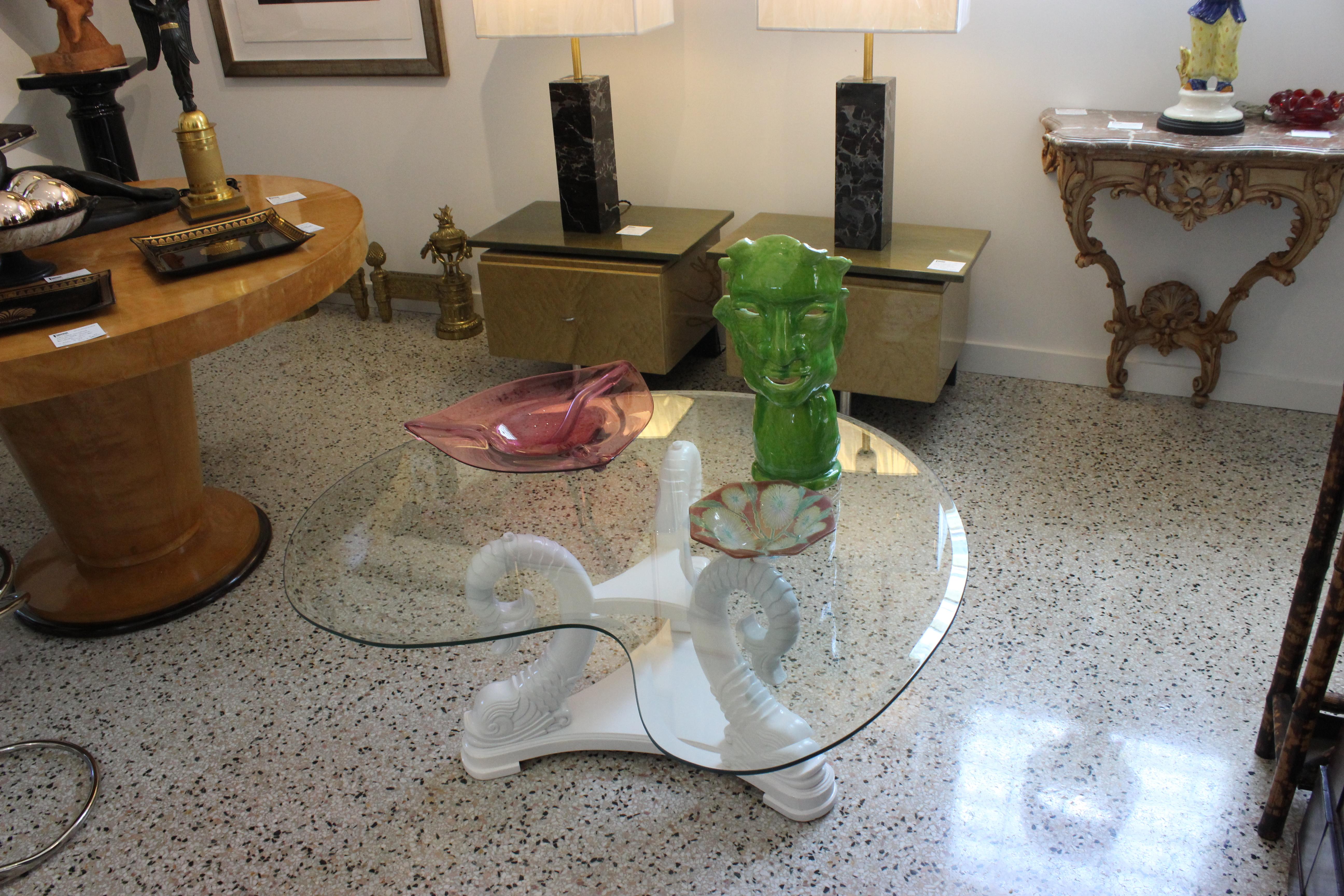 This stylish and chic Hollywood Regency inspired cocktail table dates to the 1970s and will make a definite statement with its stylized koi fish base in a high-gloss lacquered finish. And the organic form glass top gives the pieces a gracefuly and