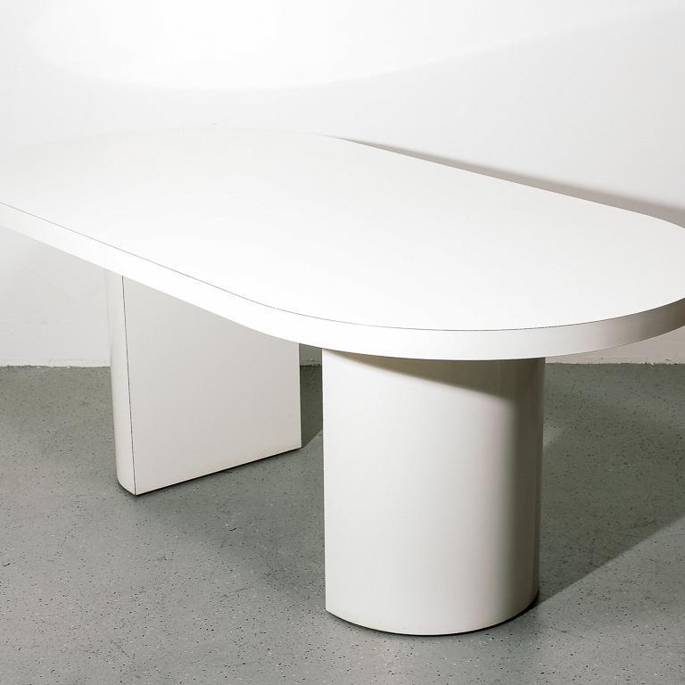 Vintage 1980s white laminate dining table. Base consists of two half-round pedestals.

27.75