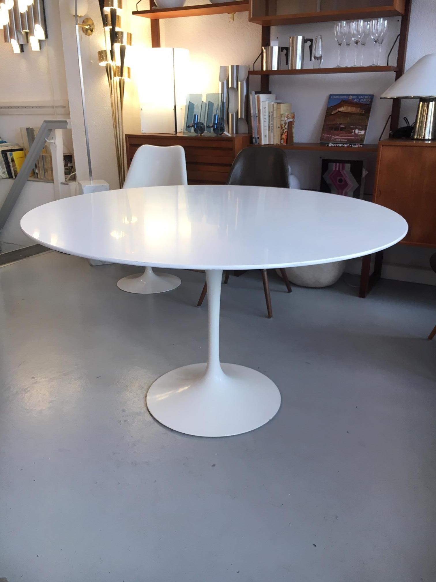 Eero Saarinen White Laminate Tulip Dining table by Knoll Switzerland, circa 1970.

Saarinen began studies in sculpture at the Académie de la Grande Chaumière in Paris, France. He then went on to study at the Yale School of Architecture, completing
