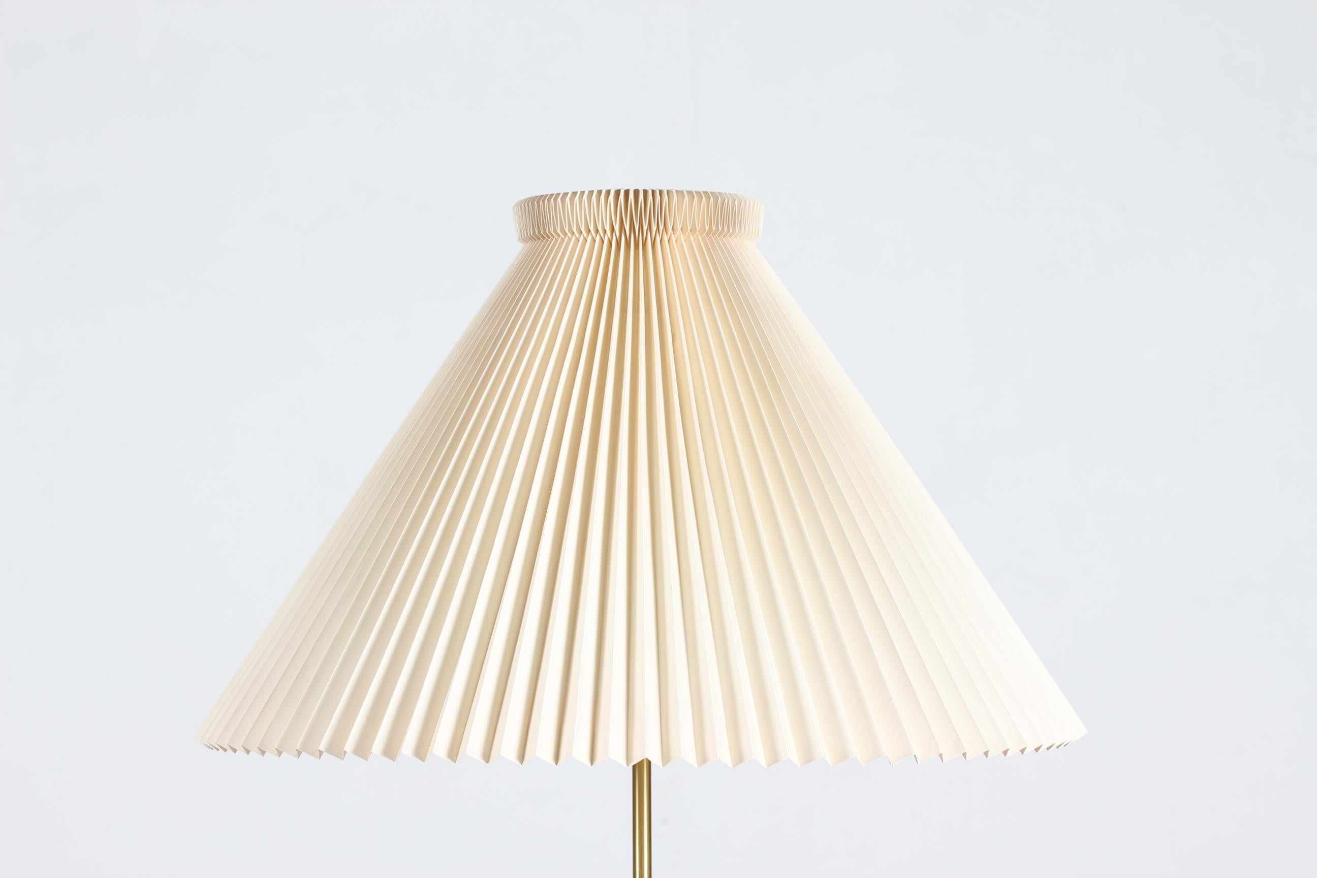 Danish mid-century floor lamp no. 351 designed by Aage Petersen for Le Klint in 1970.

The floorlamp is made of metal with off white lacquer, rare to find, and brass and has still the original Le Klint lamp shade. 
It´s possible to adjust the