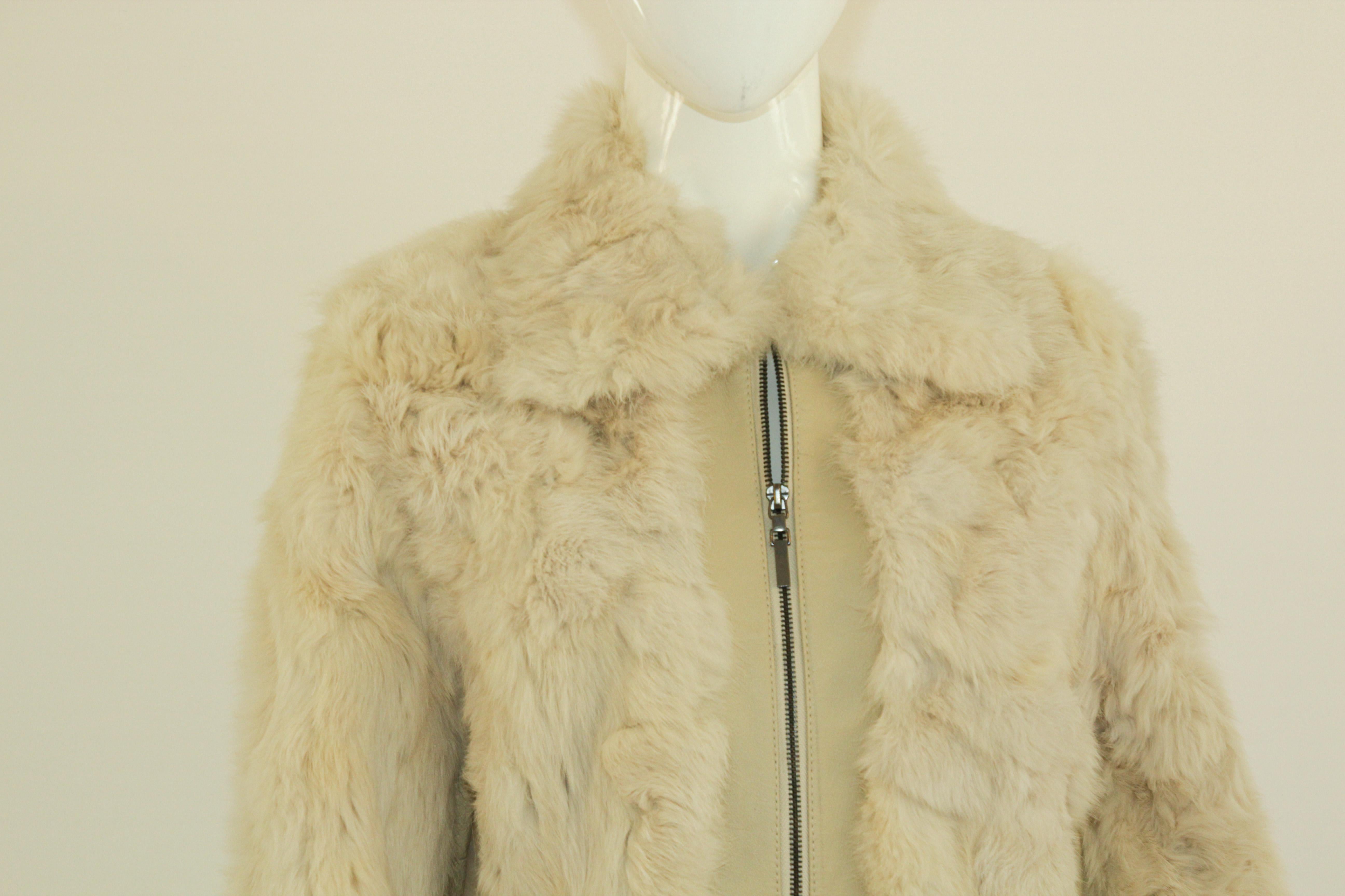 Vintage white leather and fur coat with front zipper.
Vintage Maxi long white leather coat from the 1970's.
Shell 100% genuine fur and leather, lining 100% polyester. 
Do not dry clean, specialist clean only.
Designed by Jennyfer J. 
Size