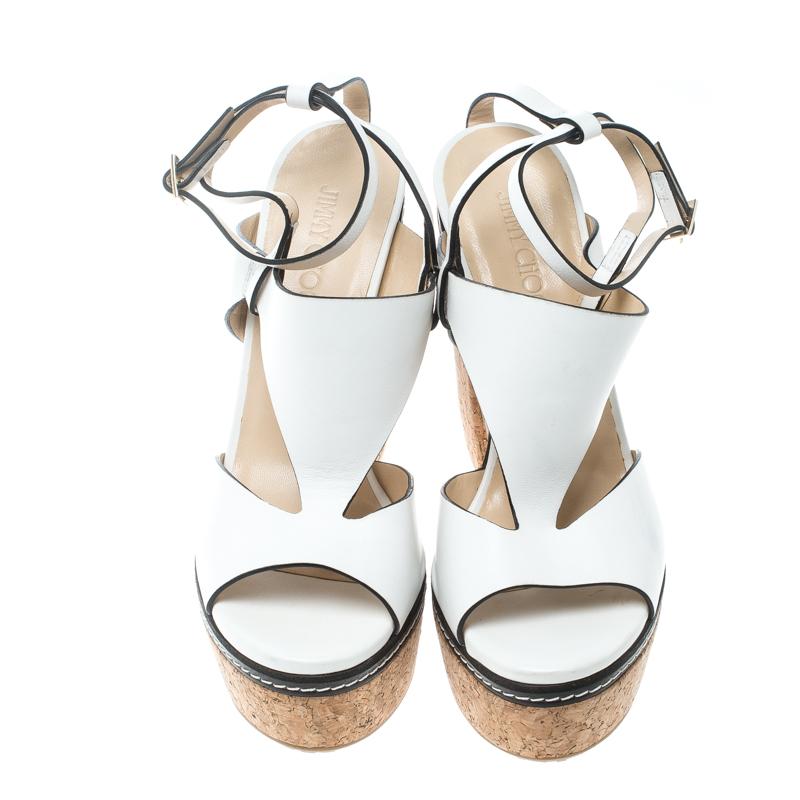 Bold, beautiful and worthy of being a part of your closet, these Jimmy Choo Noble sandals will surely make you the centre of attraction! They are crafted from white leather and feature a peep-toe silhouette. They flaunt cutout detailed vamp straps,