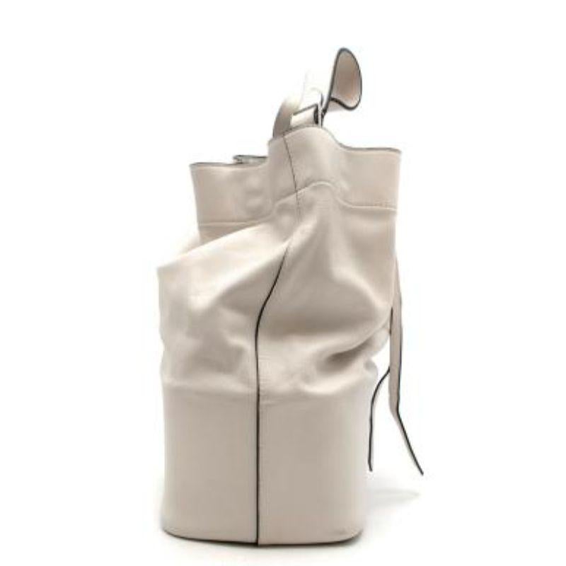 Celine white leather Seau bucket bag
 
 
 
 - Phoebe Philo era Celine
 
 - Chalk white leather exterior with black edge
 
 - Thick flat single shoulder strap
 
 - Drawstring fastening 
 
 - Gold-tone metal hardware
 
 
 
 Materials: 
 
 Calfskin
 
