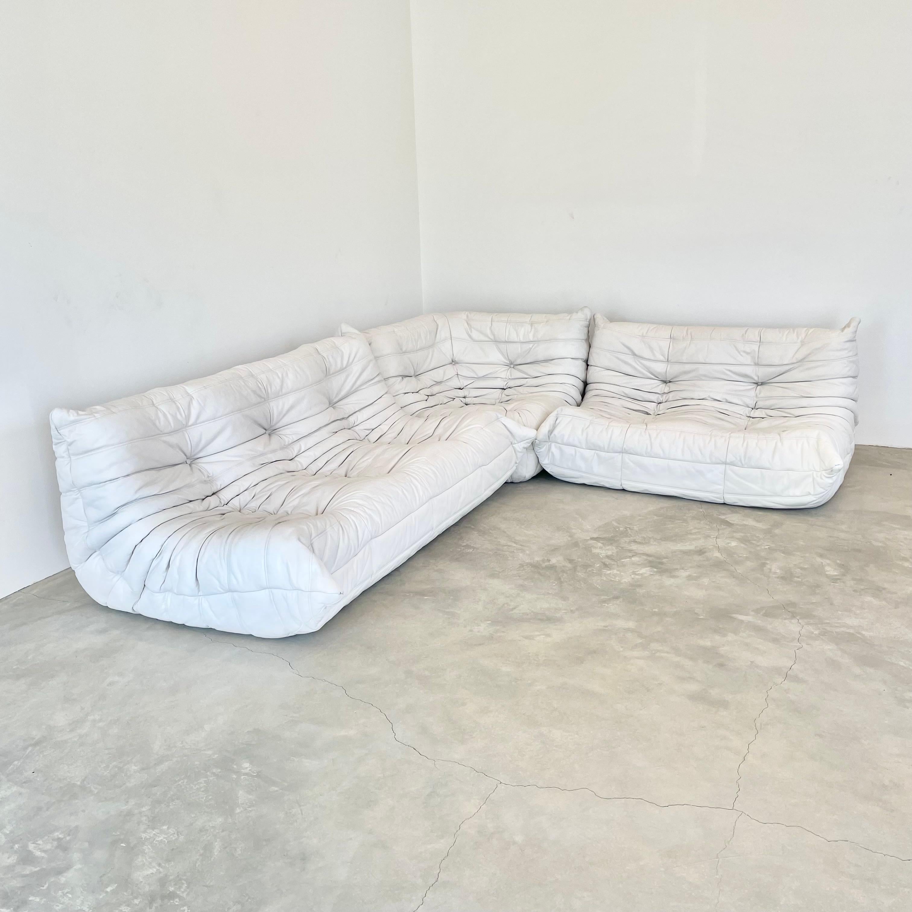 Classic French Togo set by Michel Ducaroy for luxury brand Ligne Roset. Originally designed in the 1970s, the iconic togo sofa is now a design classic. This set comes in its original white leather. Leather has been cleaned and color washed. This set