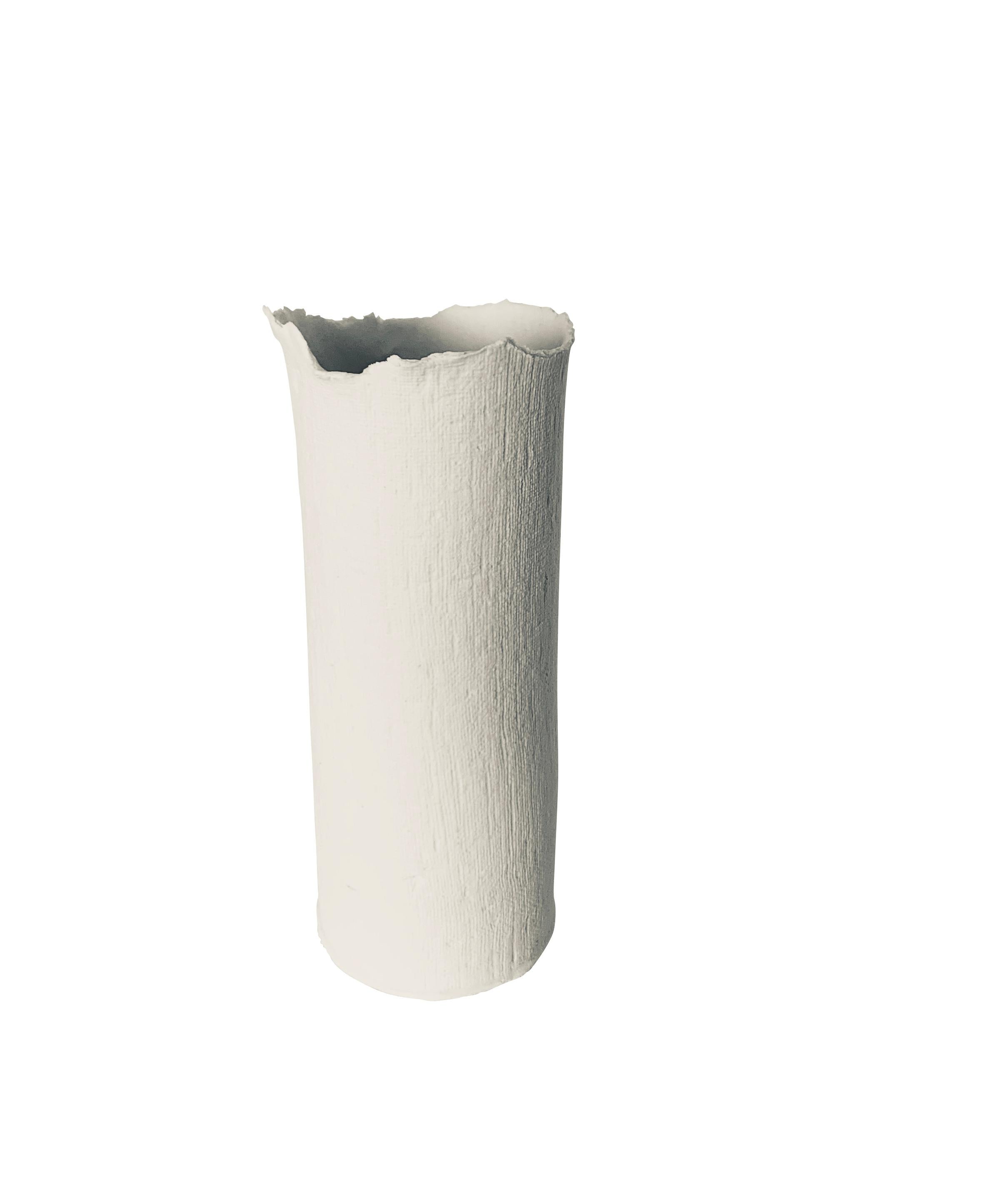 Contemporary French handmade white fine ceramic tall cylinder shaped vase is a one of a kind piece.
The vase is fine ceramic with a textured surface that looks like linen.
The mouth of the vase has an unfinished rough edge detail.
A collection of