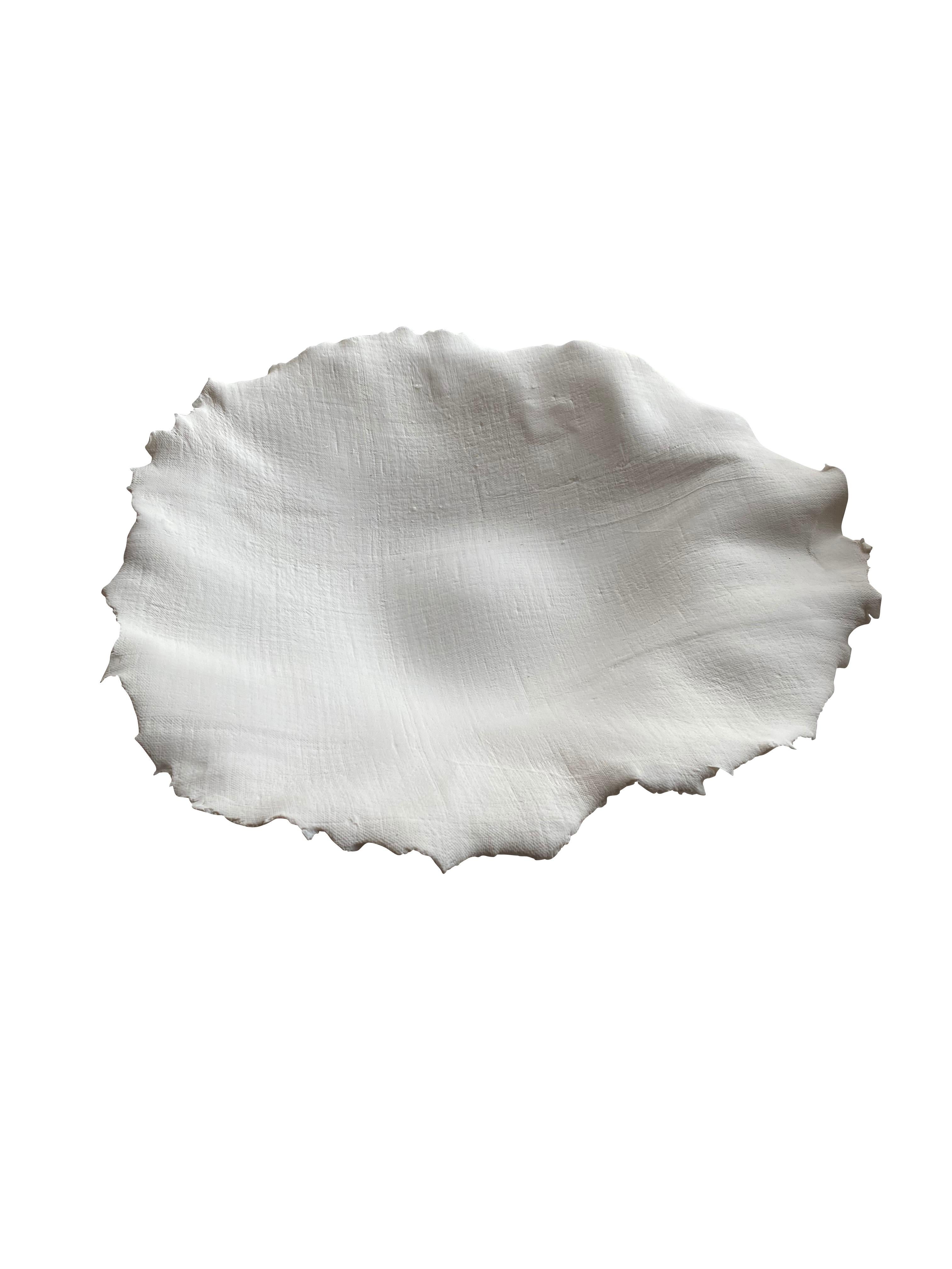 Handmade white porcelain bowl with a linen textured look.
Organic shape with decorative rough edges.
Can hold food.