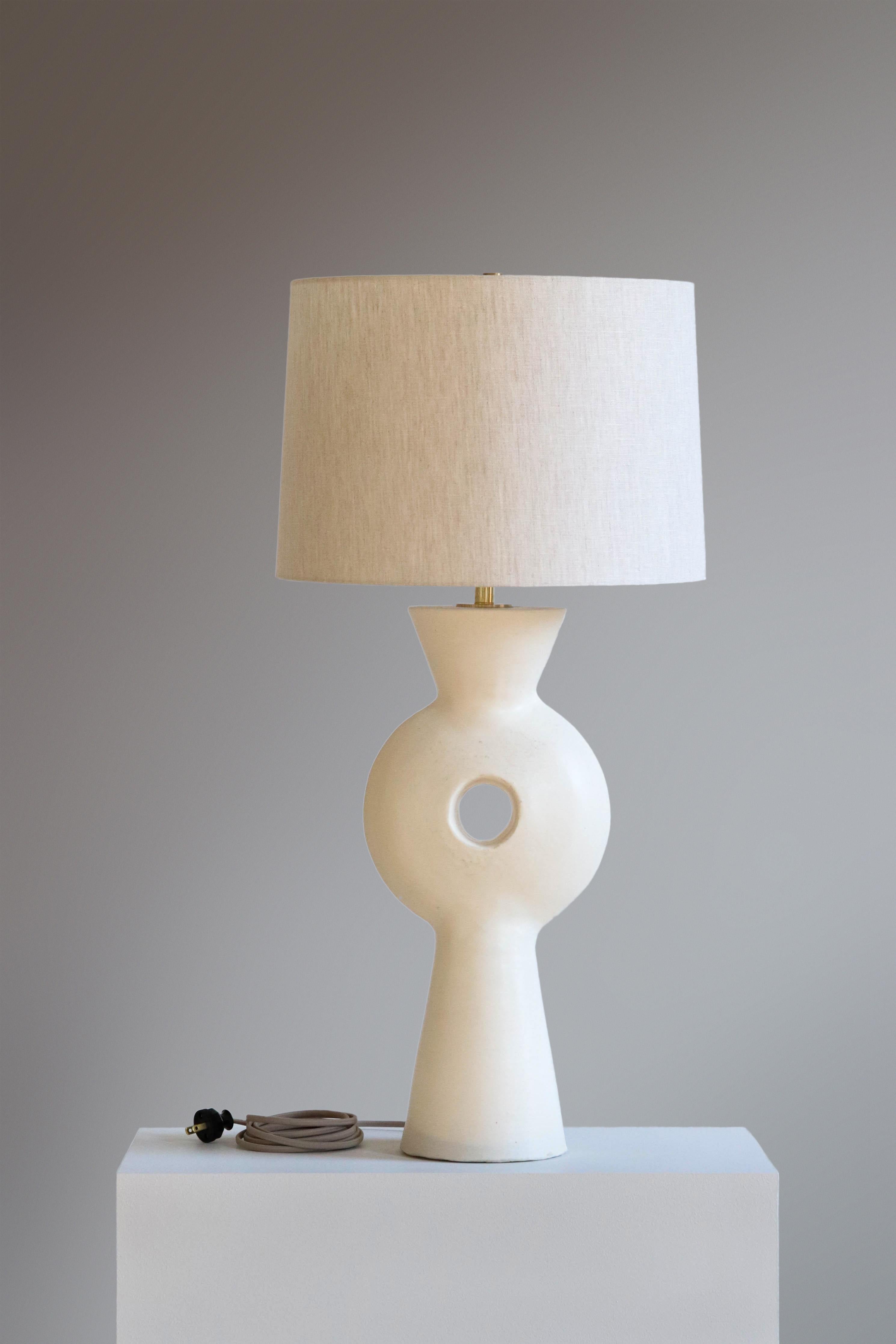 White Linus Table Lamp by Danny Kaplan Studio
Dimensions: ⌀ 41 x H 82 cm
Materials: Glazed Ceramic, Unfinished Brass, Linen

This item is handmade, and may exhibit variability within the same piece. We do our best to maintain a consistent product,