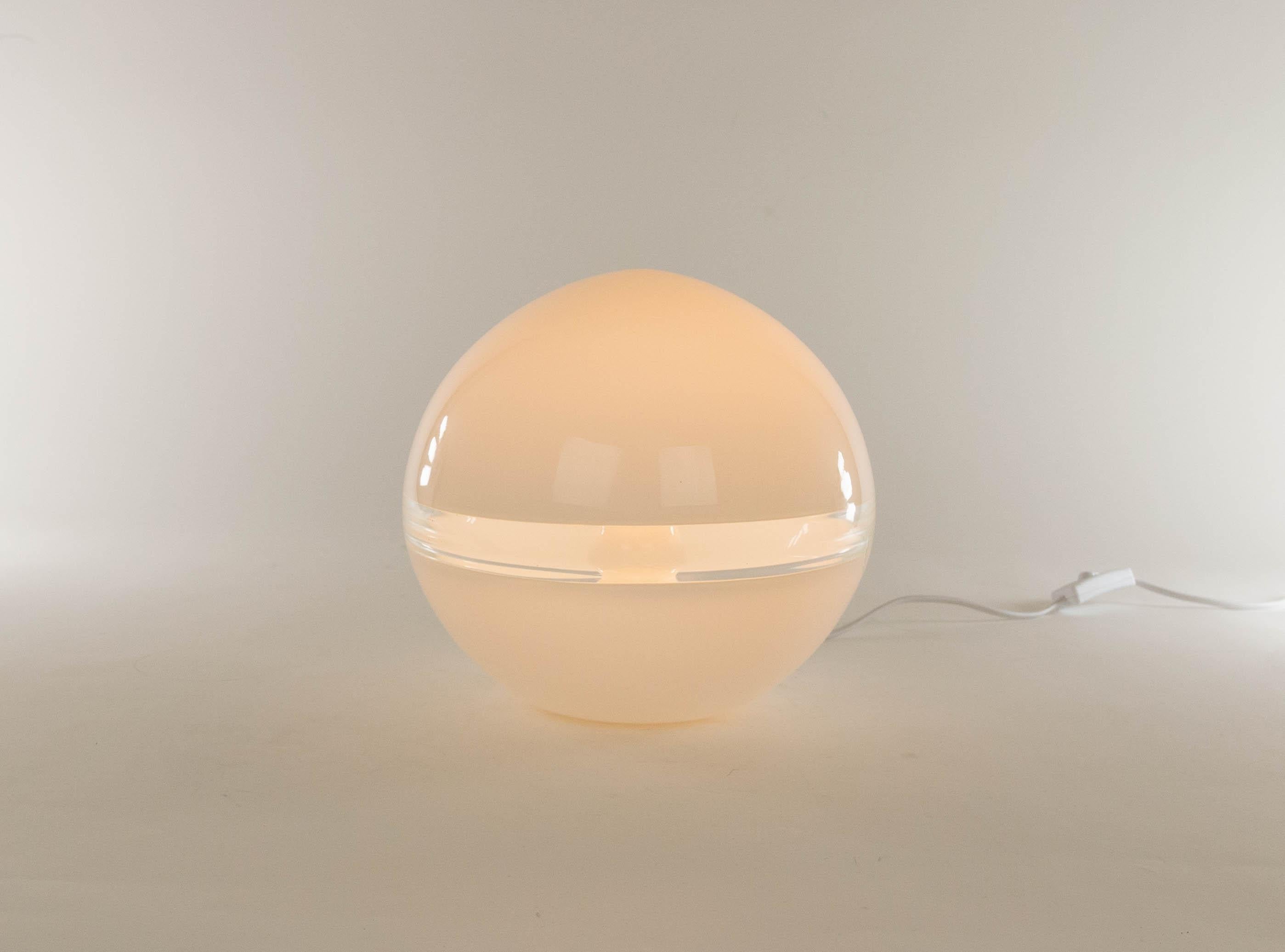 White LT 230 table lamp designed by Carlo Nason and manufactured in the 1970s by Murano glassmaker A.V. Mazzega. The lamp is made of white Murano glass and has a crystal band.

This model was produced in two sizes; this is the smaller version with