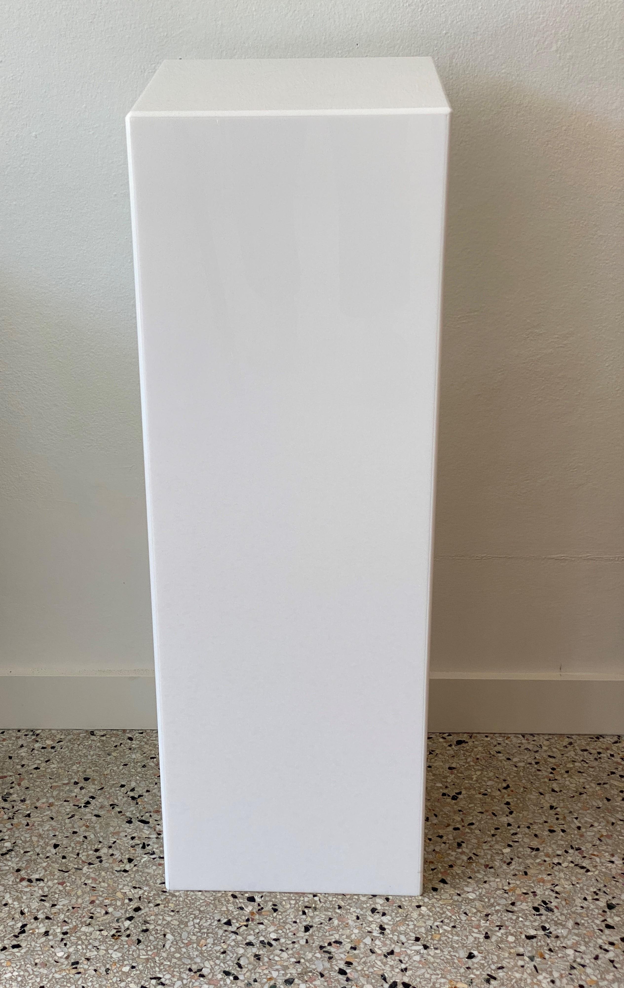 This white Lucite pedestal dates to the 1990s.