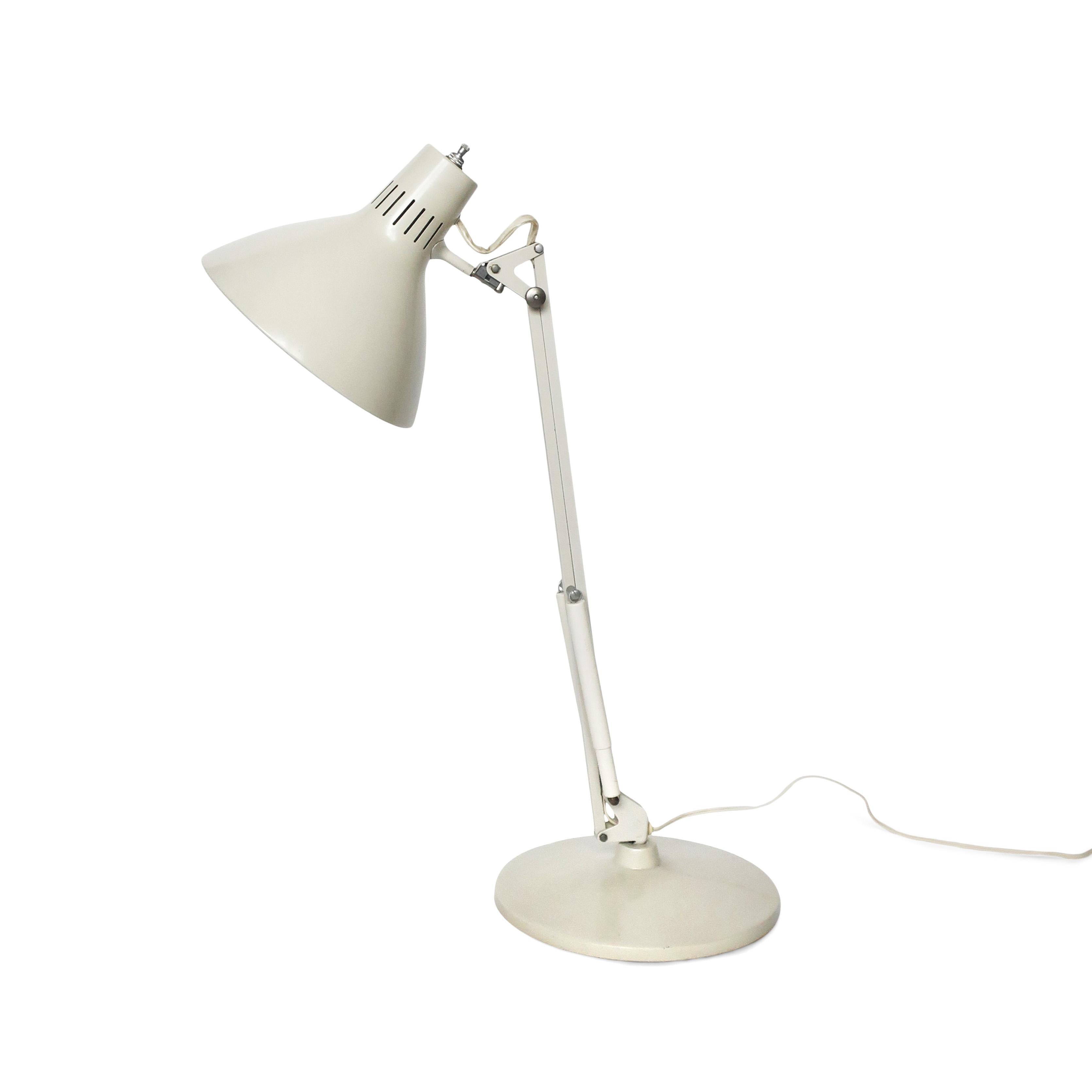 A vintage cream/off-white Luxo desk lamp with a matching weighted metal base. Perfect for a desk lamp or for a table lamp in a living room. In good vintage condition with wear consistent with age & use. Marked with the vintage Luxo logo on one side