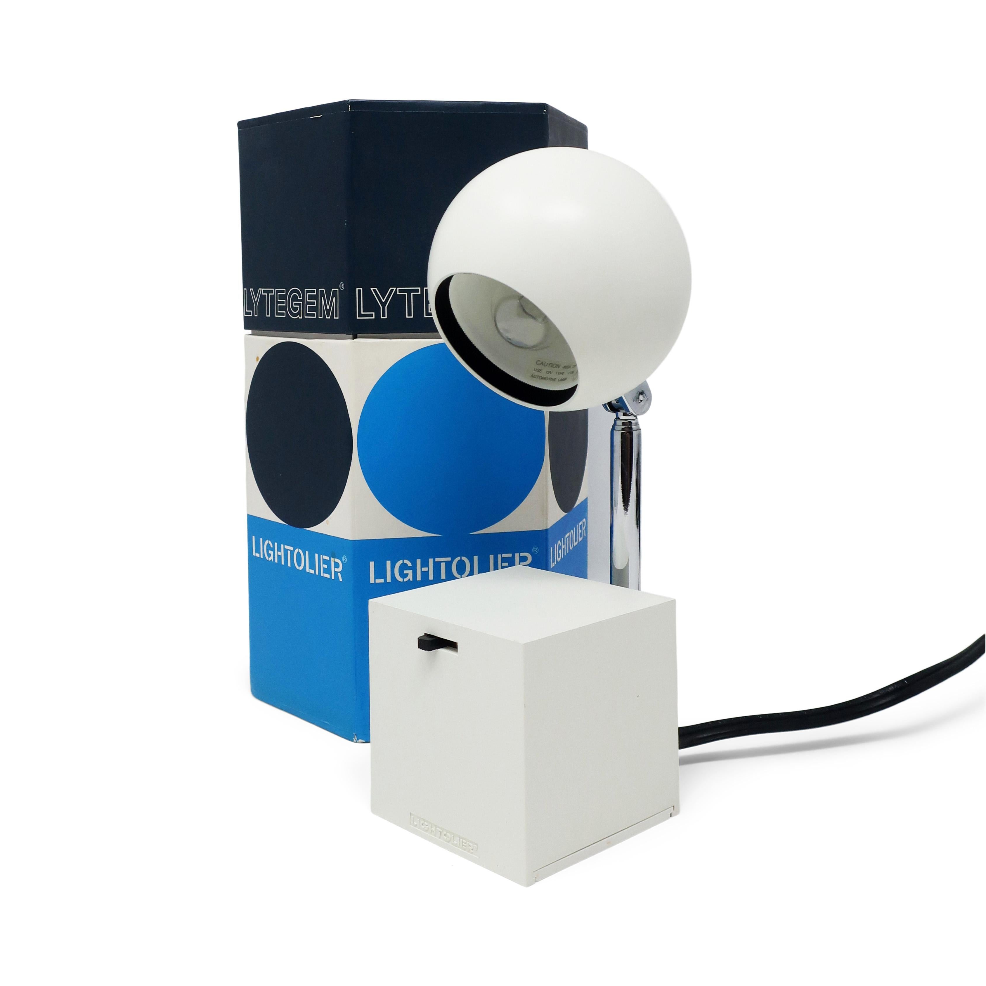 A Mid-Century Modern Lytegem desk/task lamp by Michael Lax for Lightolier (1965) with a white base and shade and extendable chrome stem, with switch for two light intensities. Can be found in the permanent collection of the Museum of Modern Art