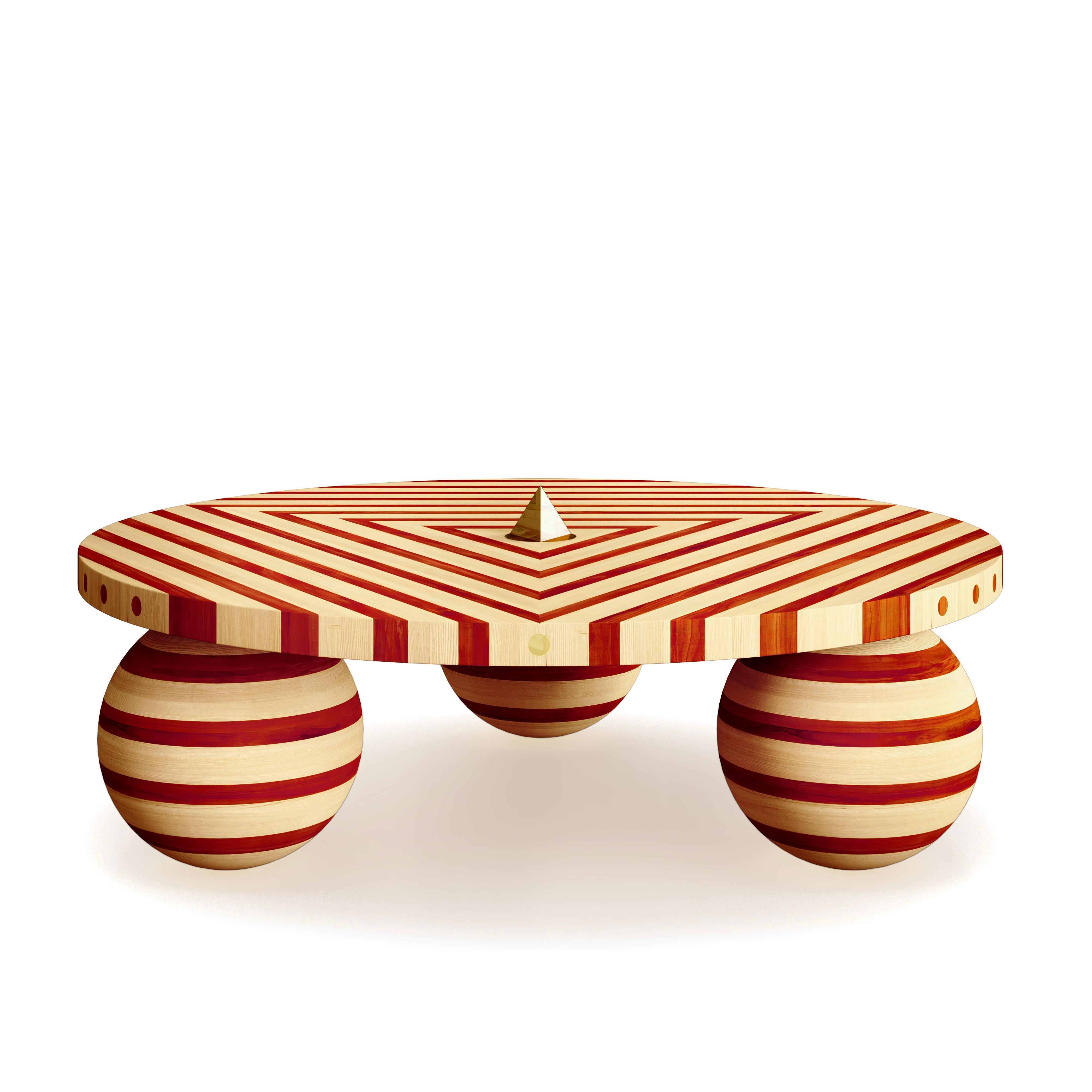 This stunning coffee table is part of the Striped series by Troy Smith Studio.

This coffee table is totally unique and original and 100% crafted by hand out of solid Maple wood from North America and Padauk sourced from Africa. The center of the