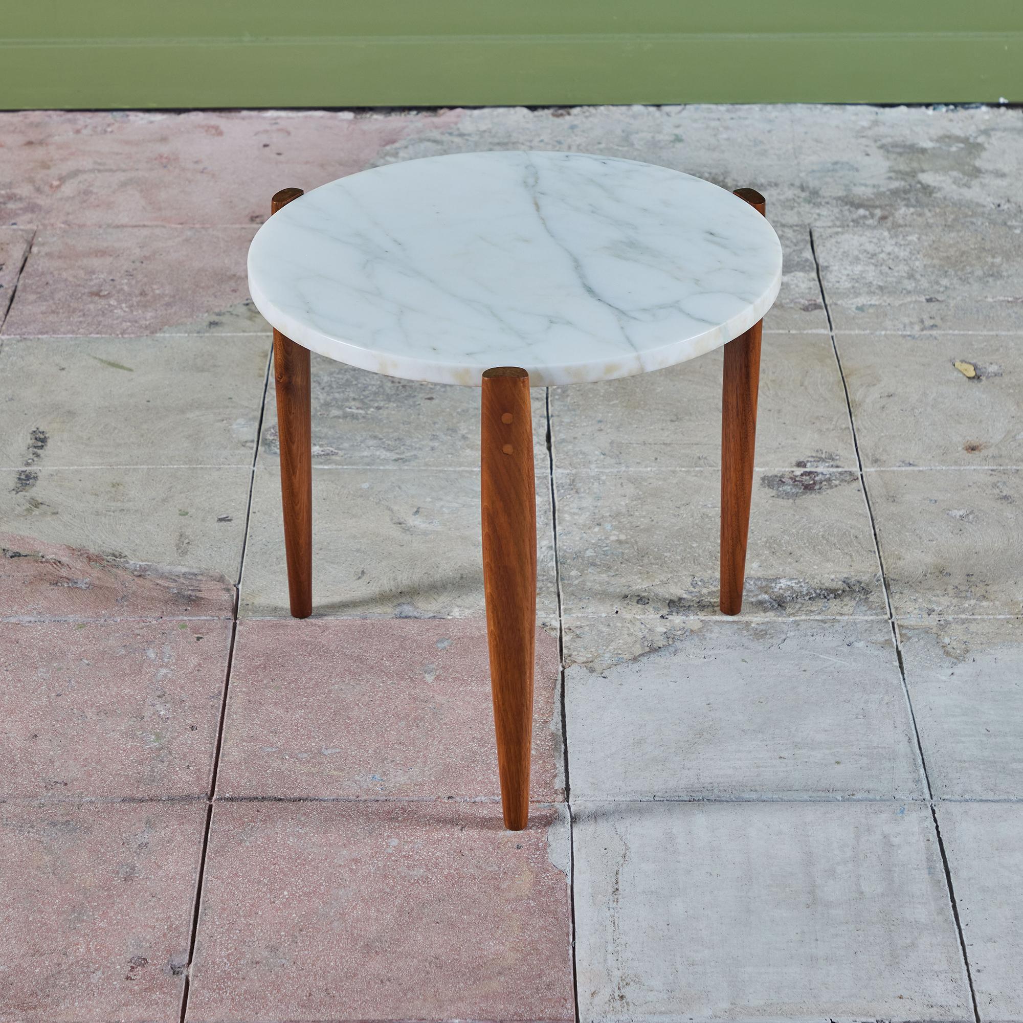 Marble top side table with a walnut tripod base. The table features a removable round table top which rests on a tapered three legged walnut base. 

Dimensions
18.75