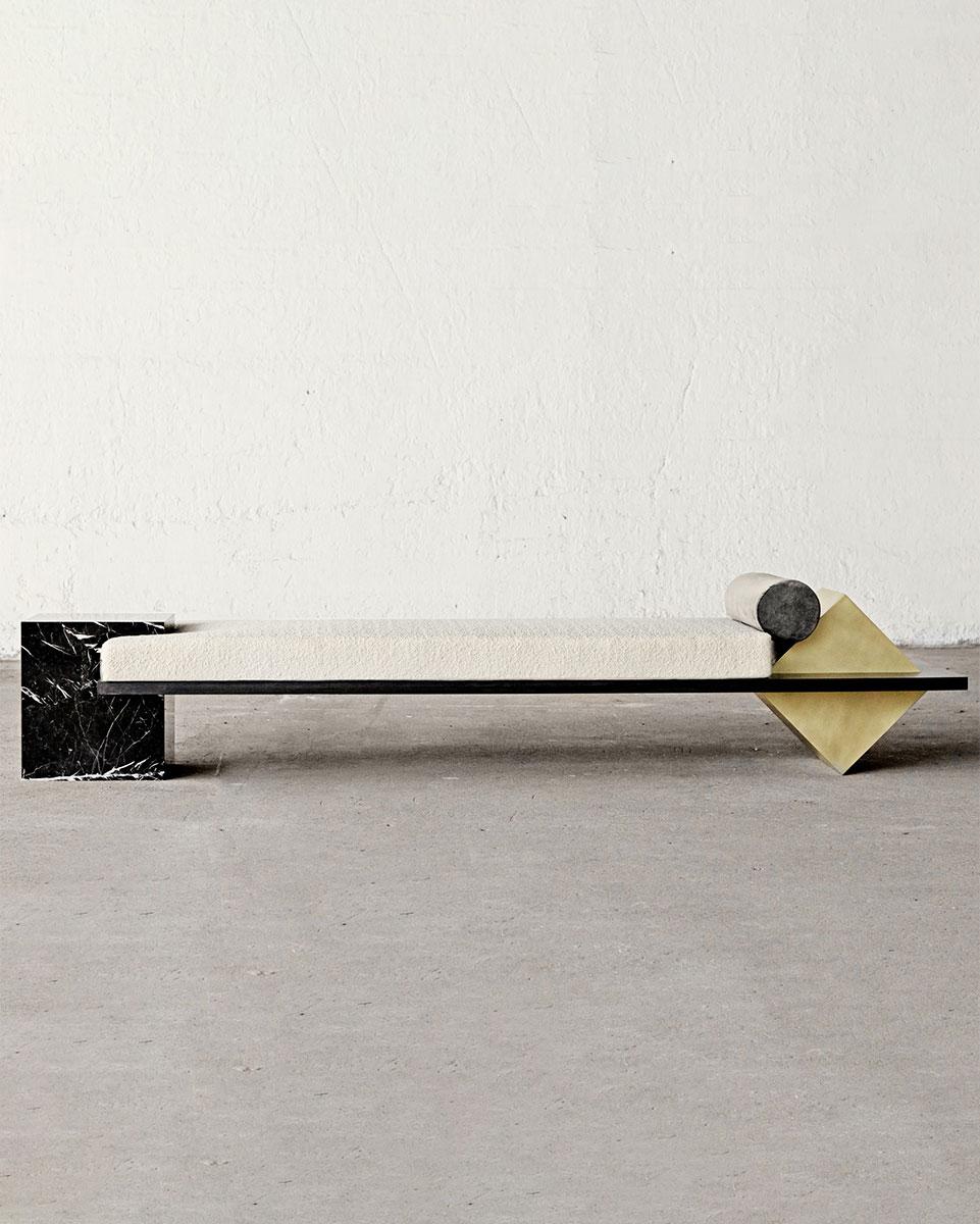 The Coexist daybed consists of a black steel frame, Nero Marquina marble cube, polished brass cube, and mattress upholstered in bouclé fabric. 

The piece holds space in suspension through the daring move that turns the brass cube on its finest