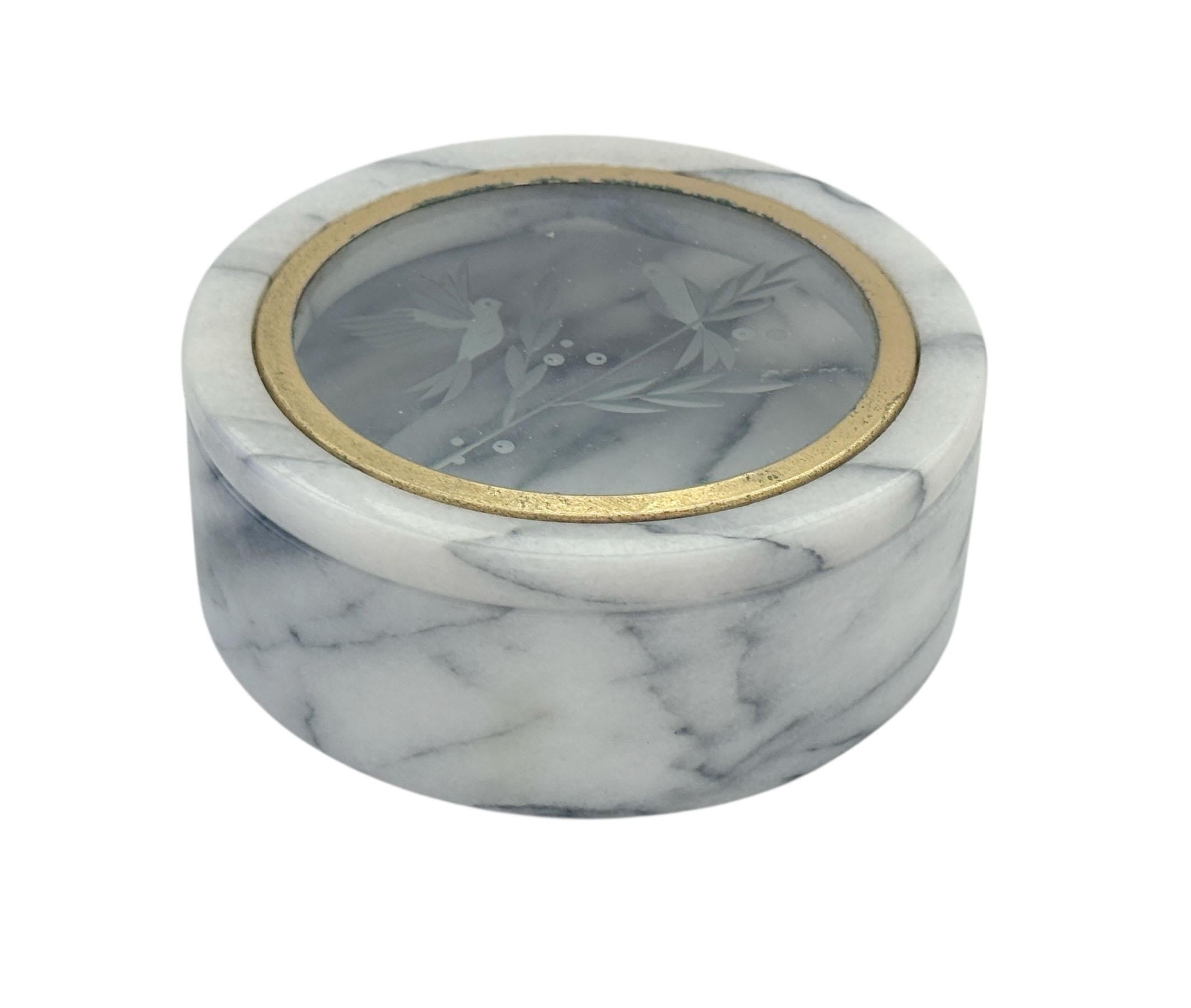 Crafted from solid white marble with elegant gray veining, this refined box features a clear glass lid etched with a delicate design. The natural stone adds weight and timeless beauty, while the etched glass top offers a subtle decorative touch.