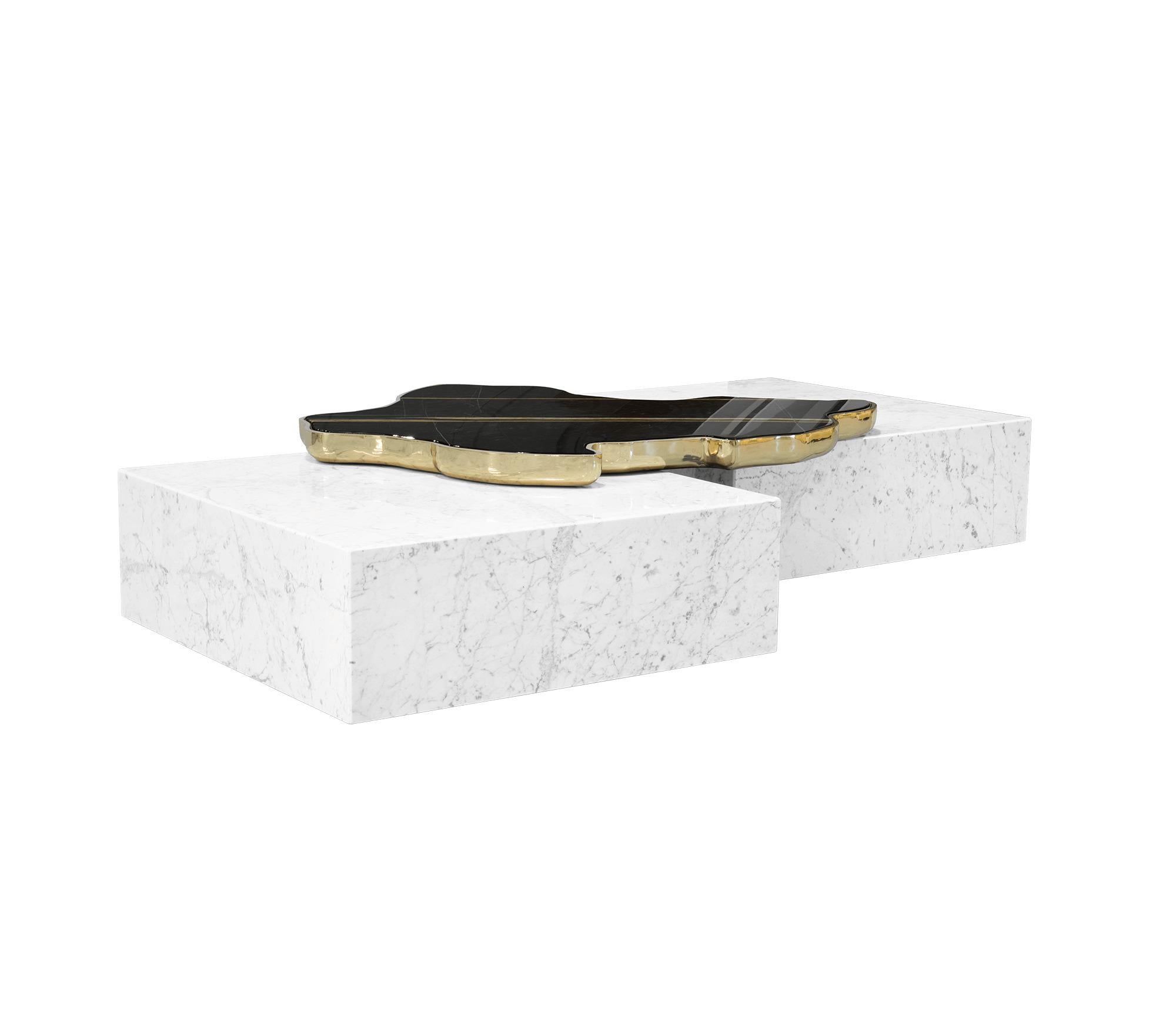 White marble center table.

Beautiful contemporary center table composed of two square marble modules, connected by an organic marble surface element on top wrapped in cast brass.

Dimensions: H: 35 cm, W: 206 cm, D: 136 cm

Production time 12