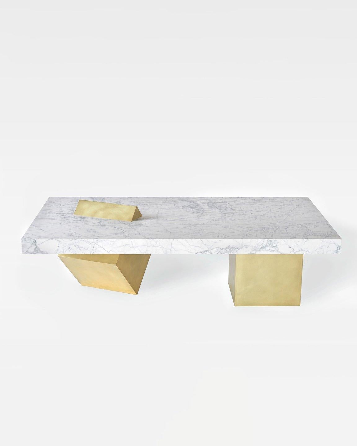 The coexist coffee consists of white venato marble tabletop and brushed brass cube base. 

A brass cube leg stands on its knife-edge and seamlessly slices through the table’s thick marble top, relying on the stone’s weight to maintain balance. A