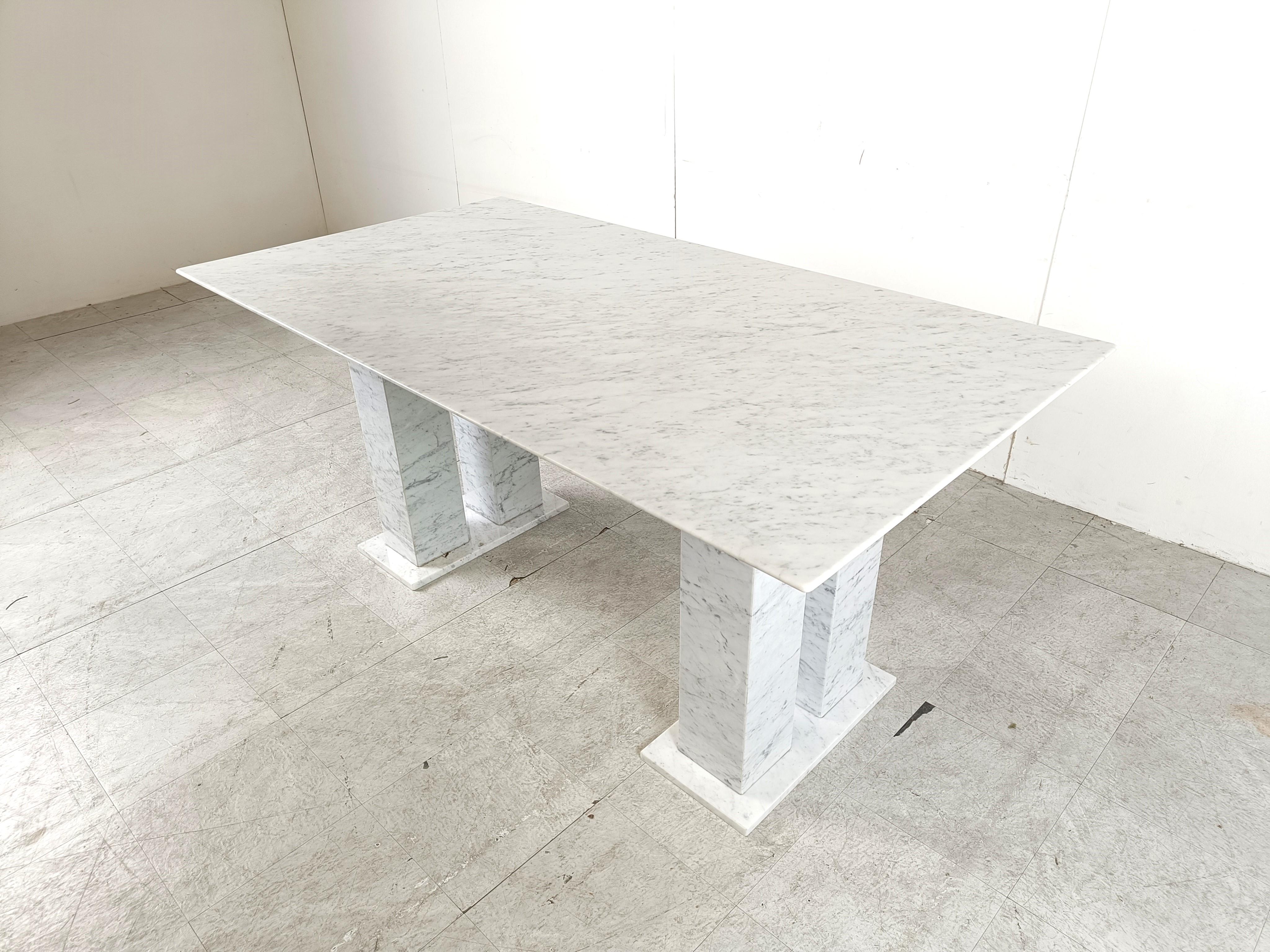 Timeless and elegant white marble dining table with double column bases on each side.

Architectural dining table with a beautiful rectangular top.

Gorgeous natural vains.

1970s - Italy

Height: 73cm/28.74