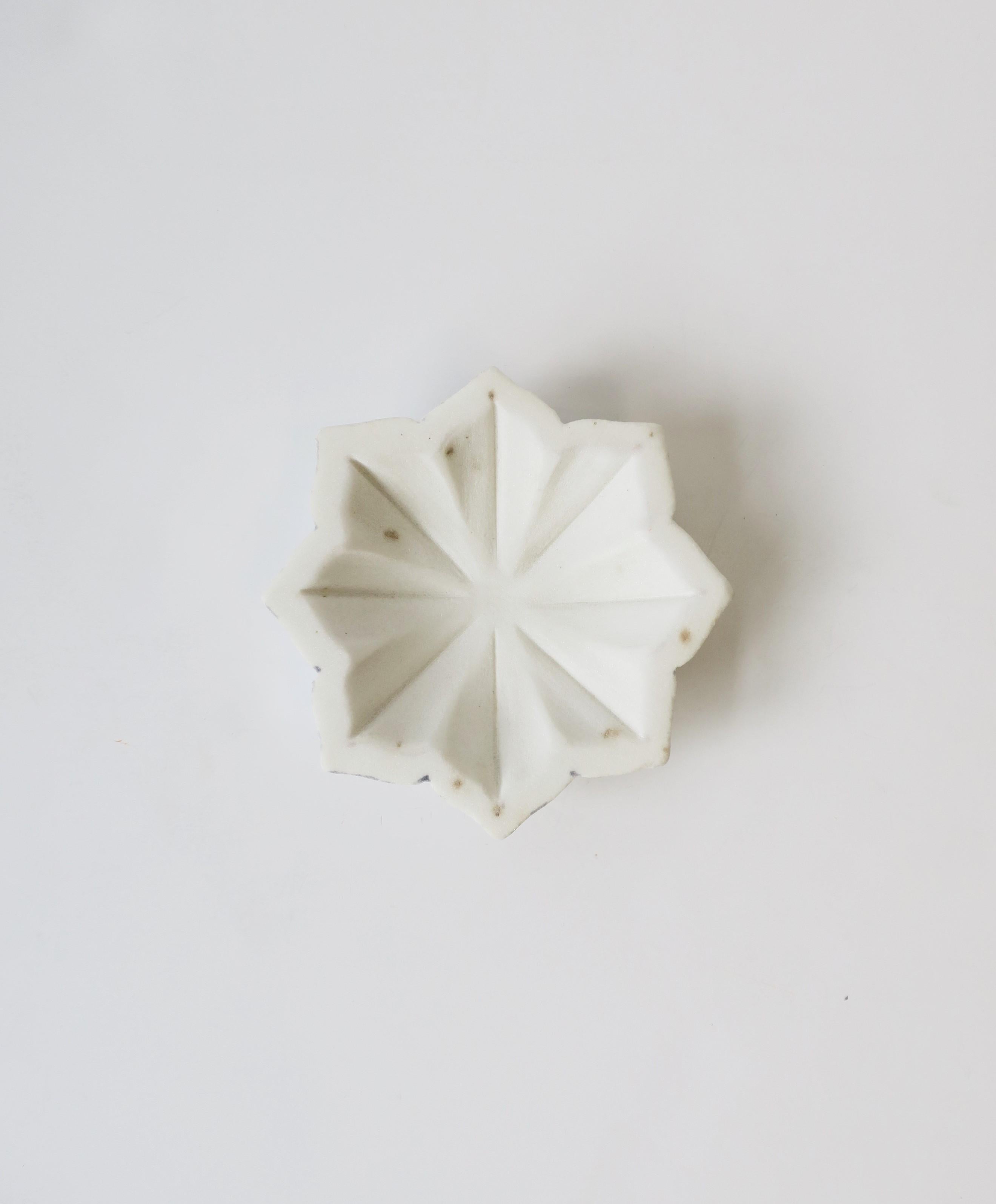 A beautiful white marble star-flower hand carved dish from a single piece of white marble. A great accent piece, as a jewelry dish, or vide-poche (catch-all) for small items on a desk, vanity, bathroom, etc. Piece measures: 5.75