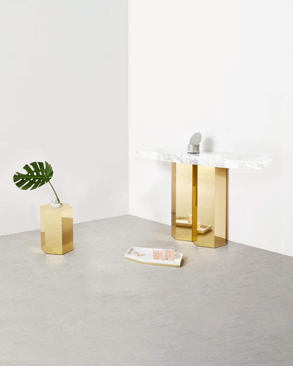 The double hex console consists of calacatta marble table top supported with brass hexagon base. 

The base features two polished brass finish hexagons which are joined together side by side. The marble top is a five-sided polygon with a