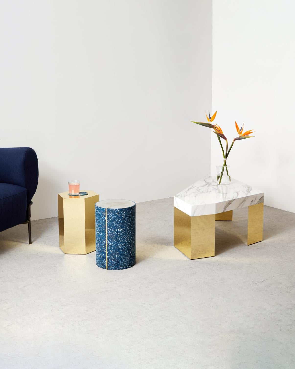 The Gem table features a calacatta marble tabletop supported with brass finish legs. 

The irregular shape allows the table to have a different appearance from each angle. The geometrical shape of the tabletop is enhanced with the gold veining of