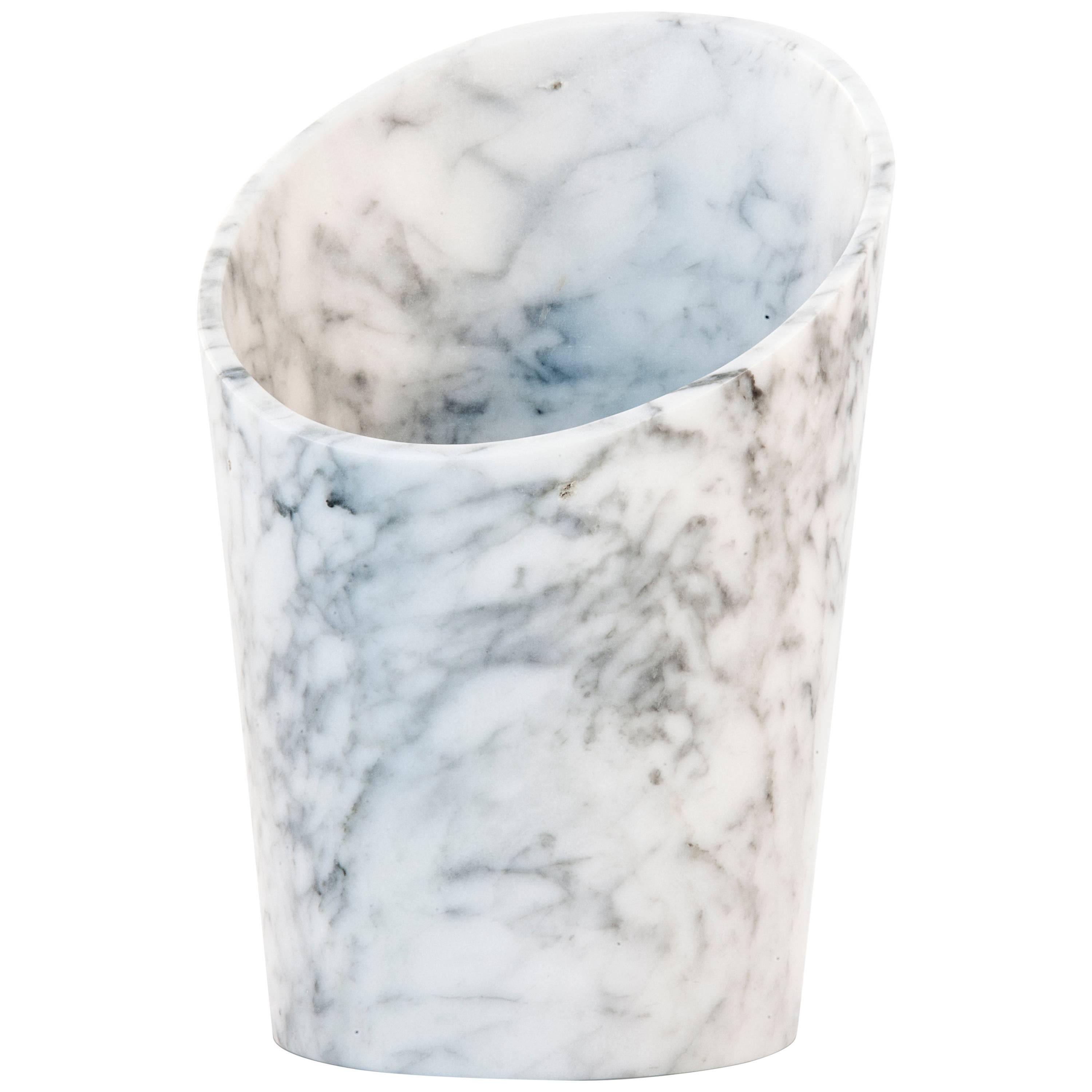 White Carrara marble single glacette for wine and champagne bottles. Each piece is in a way unique (since each marble block is different in veins and shades) and handcrafted in Italy. Slight variations in shape, color and size are to be considered a