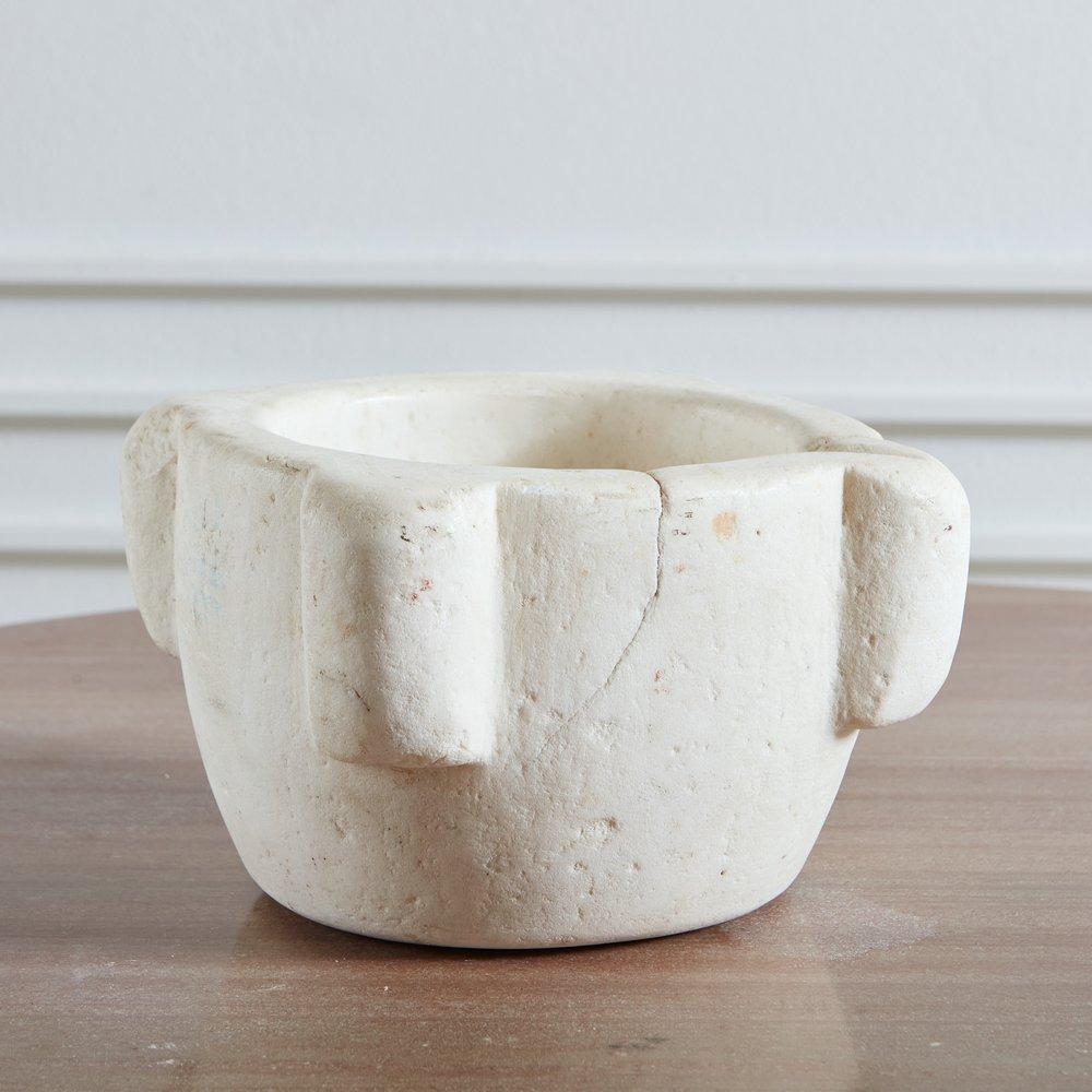 A gorgeous vintage white marble mortar featuring beautiful patina and time honored wear. Sourced in France, 20th century.
