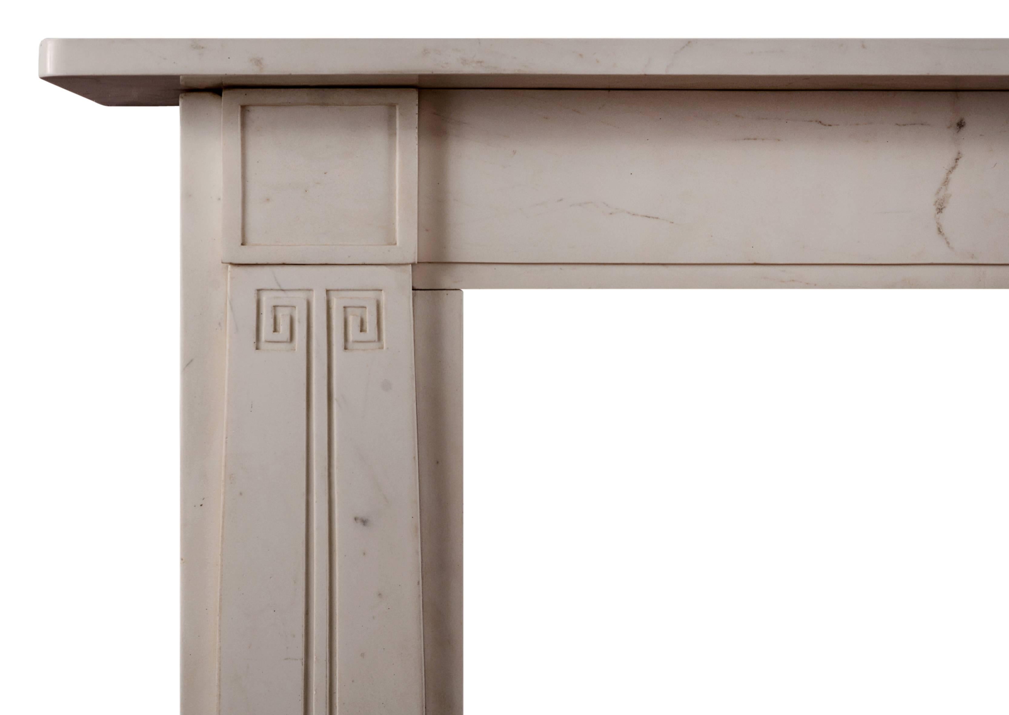 A white marble fireplace in the manner of Sir John Soane. The tapering jambs with Greek key decoration, surmounted by square panelled blockings. Plain frieze and shelf. English, based on an original piece.

N.B. May be subject to an extended lead