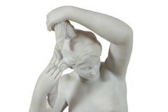 White Marble Statue of Nude Beauty on Charcoal Pedestal
