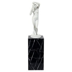White Marble Statue of Nude Beauty on Charcoal Pedestal
