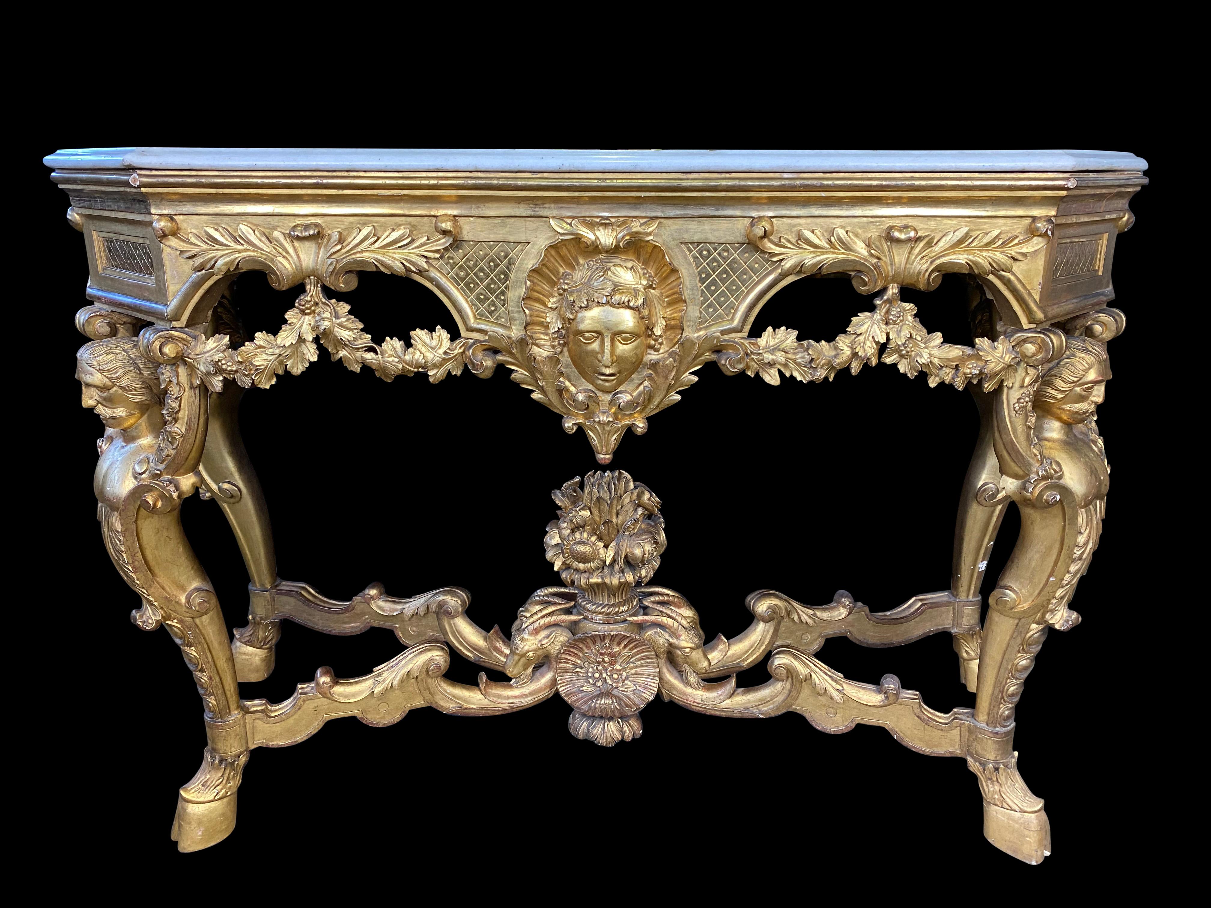 An elaborately carved and gilded Italian console in the Rococo taste, the shaped white marble top lies above a flower-filled pattern with trailing blossoms, alongside the gilded decoration. Exceptionally hand crafted from the 18th-19th century.