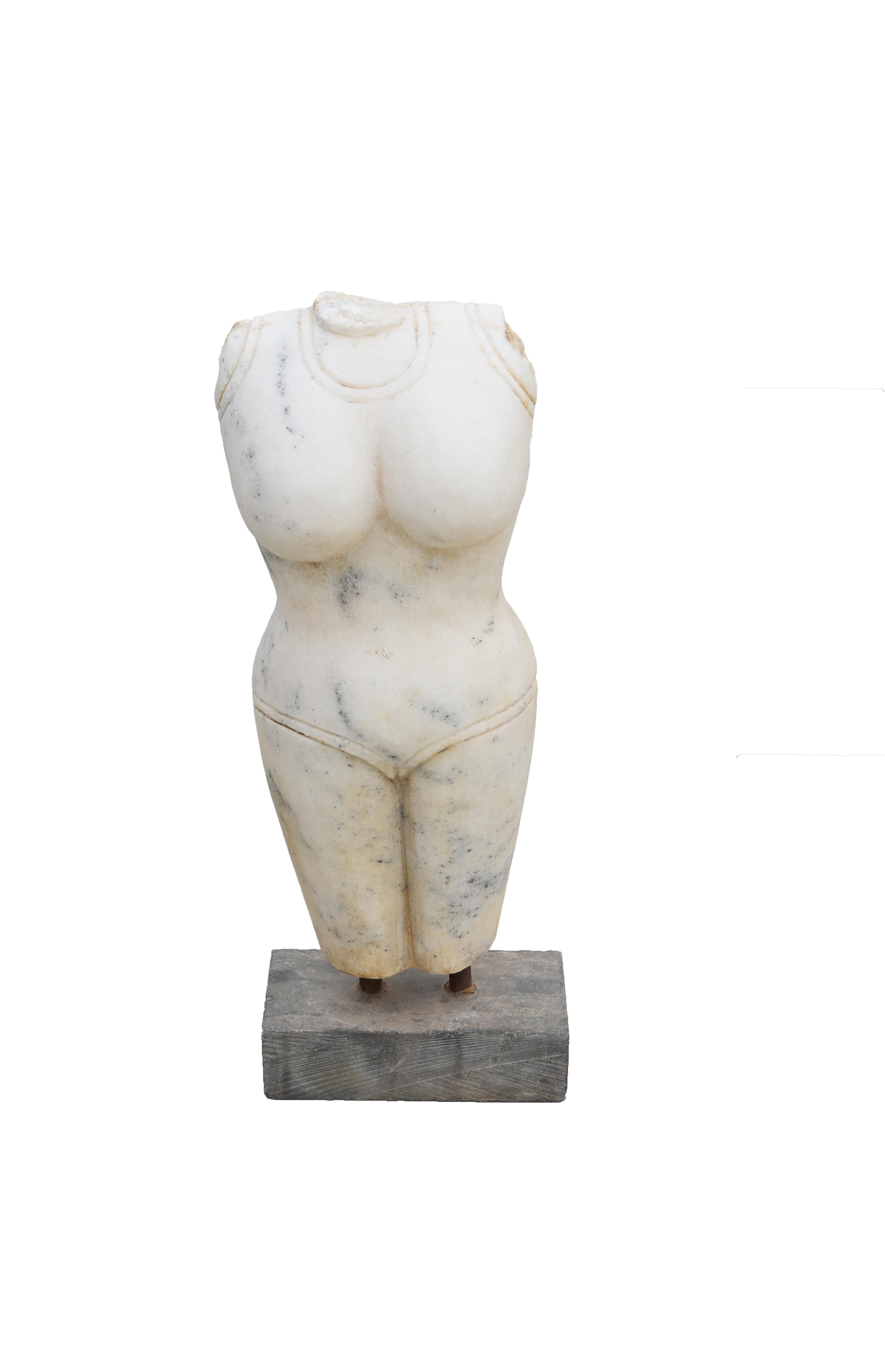 A beautiful Carrara marble torso of an Indian goddess. The torso with the diaphanous sarong wrapped around the body and secured with double belts at the waist. The female body beautiful with full bosom and robust legs, all symbols of good health and