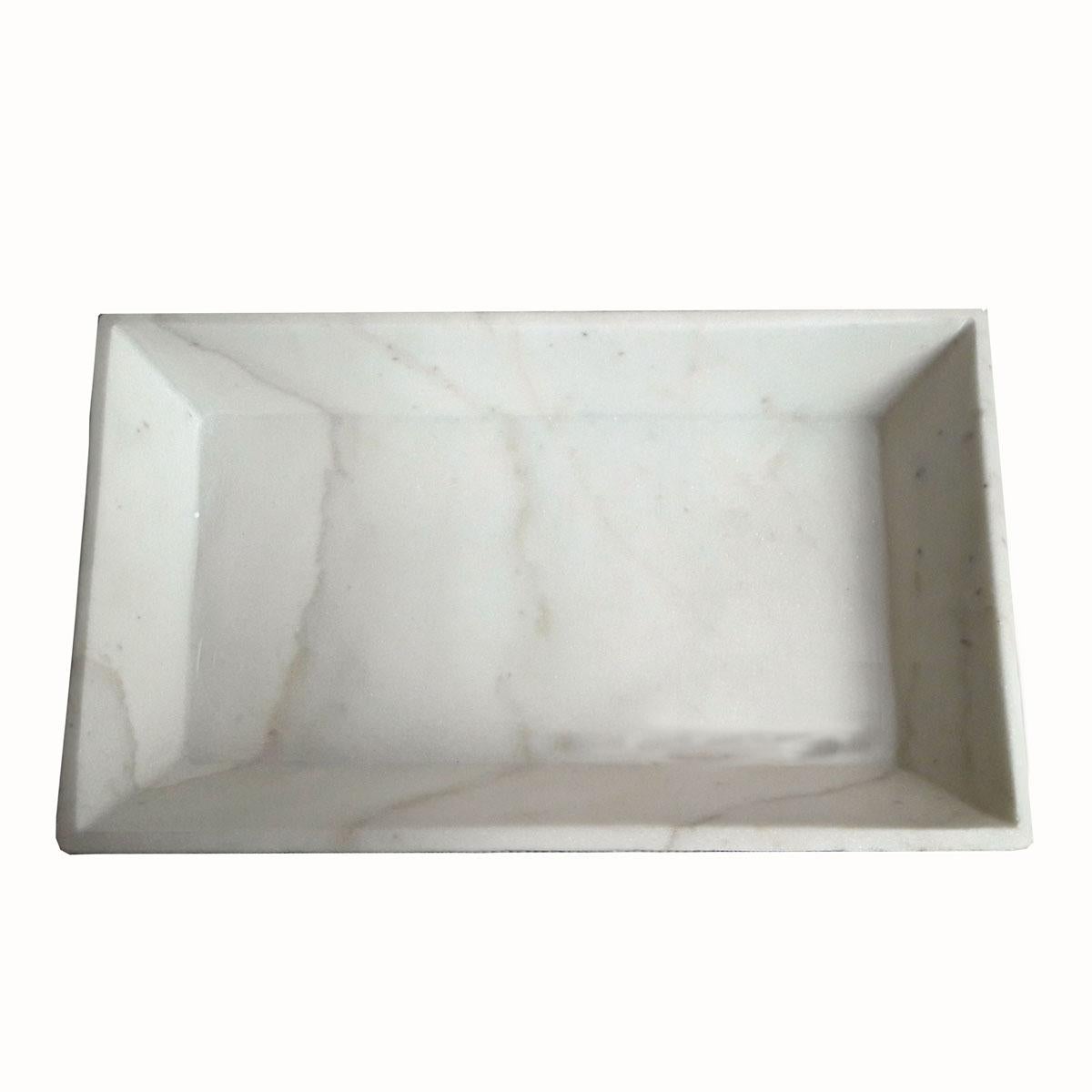 A white marble tray from India with beveled sides. Sleek and elegant, this small tray is ideal as an accessories tray for a bedroom vanity, a bathroom hand towel tray, or as a decorative element in any other room.