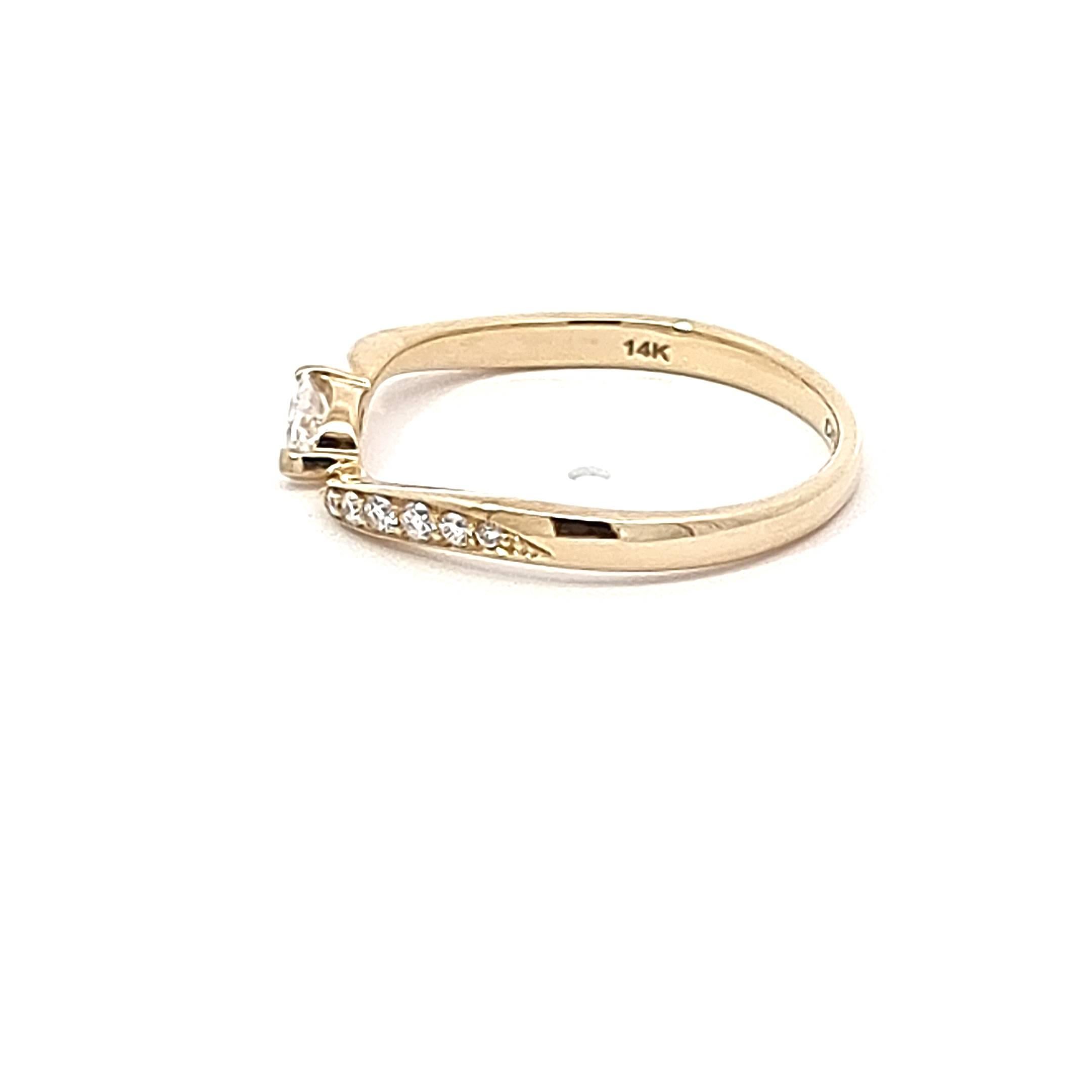 Adorn your finger with the timeless elegance of our 14K Yellow Gold Ring, a masterpiece of design and craftsmanship. The curvaceous shank adds a touch of whimsy to this sophisticated piece, creating an aesthetic harmony. At the heart of the ring, a