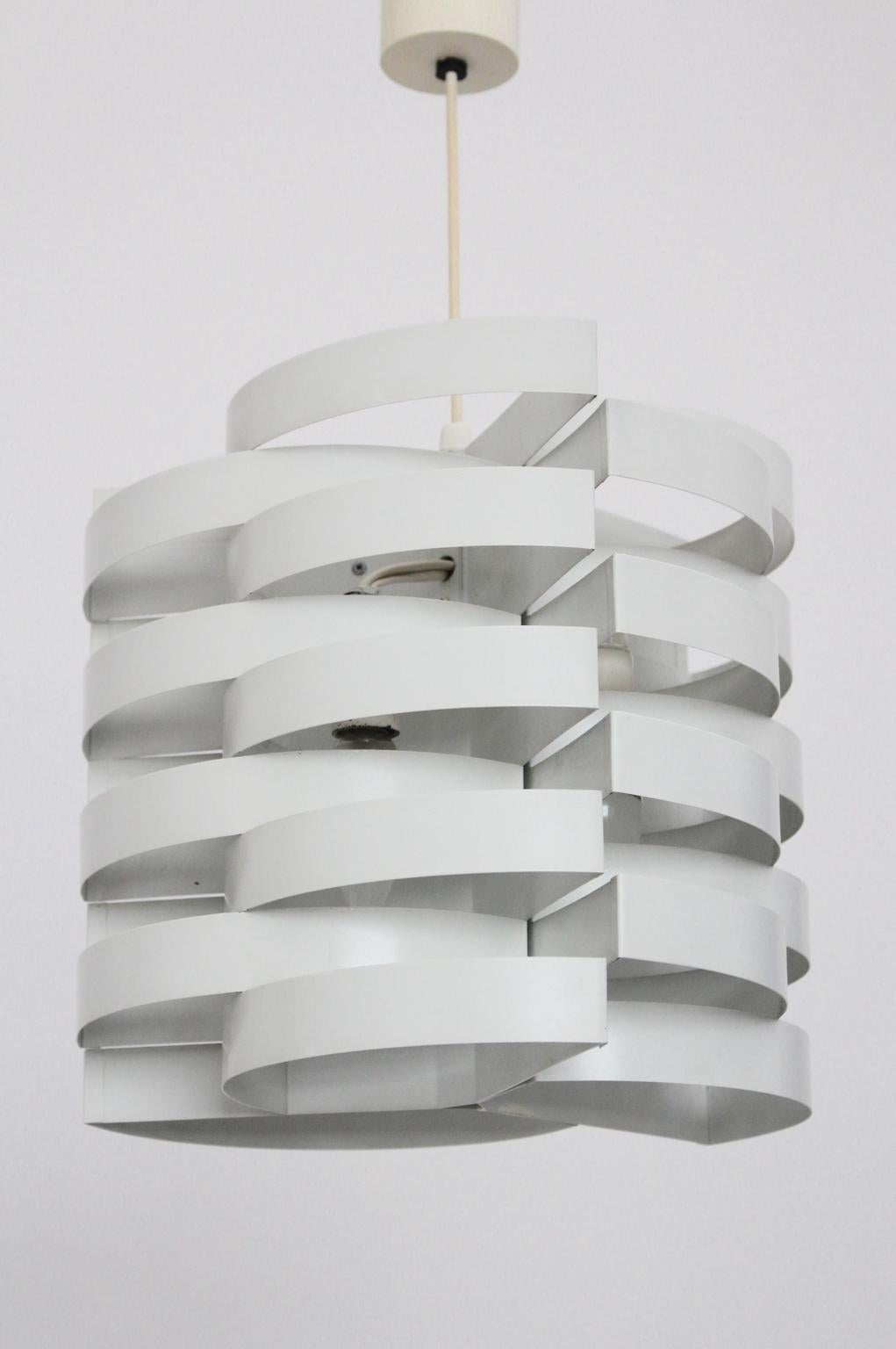 This futuristic white lacquered metal construction was designed by Max Sauze. The metal structure provides you with an indirect and cosy light shine.

The chandelier has three E 14 sockets.
Very good original condition

approx. measures: diameter 30
