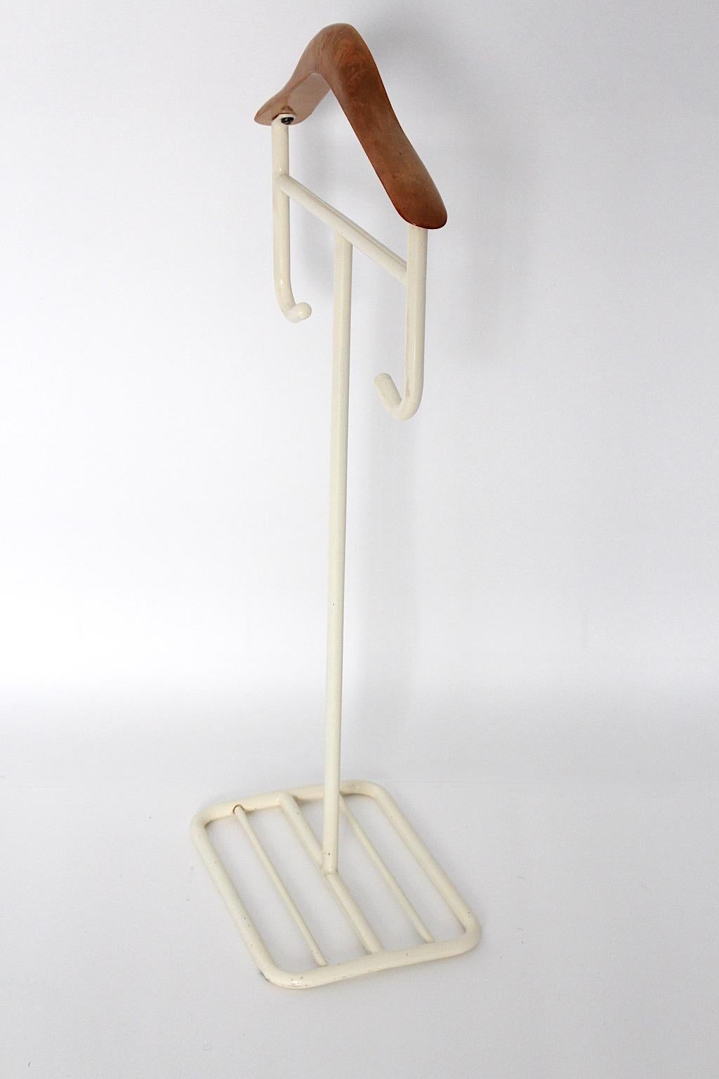 Bauhaus style vintage valet or coat rack from lacquered tube steel and beech in white and brown color circa 1930 Germany.
A sleek and sophisticated valet or coat rack from lacquered metal and beech designed and made circa 1930 Germany.
Throughout