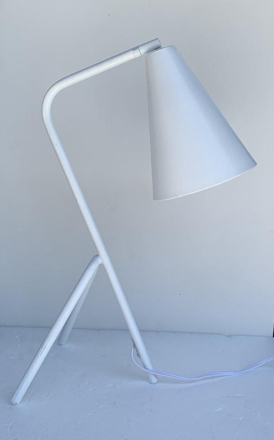 Beautiful and sculptural table lamp manufactured my the Japanese lighting company Tarogo.

The lamp has a tripod base, the metal shade can be moved to direct the light according to your needs, the metal is finished powder coated in white