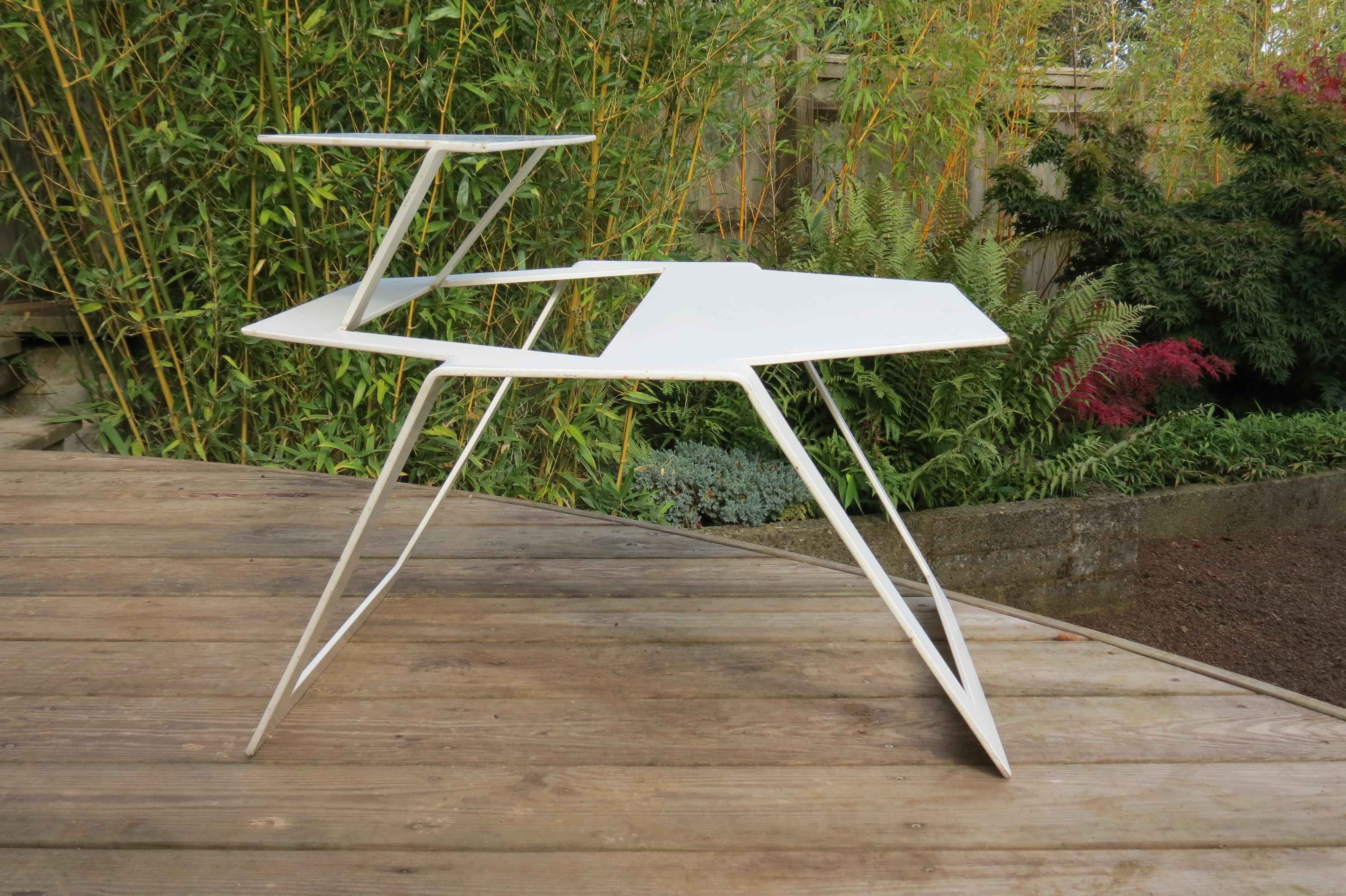 A very good quality metal table from the 1990s, good quality thick steel. Very cleverly cut and formed from one sheet of metal. Possibly a prototype.
Good over all condition, some wear and minor loss to the paint and distressing over all. 
Price is