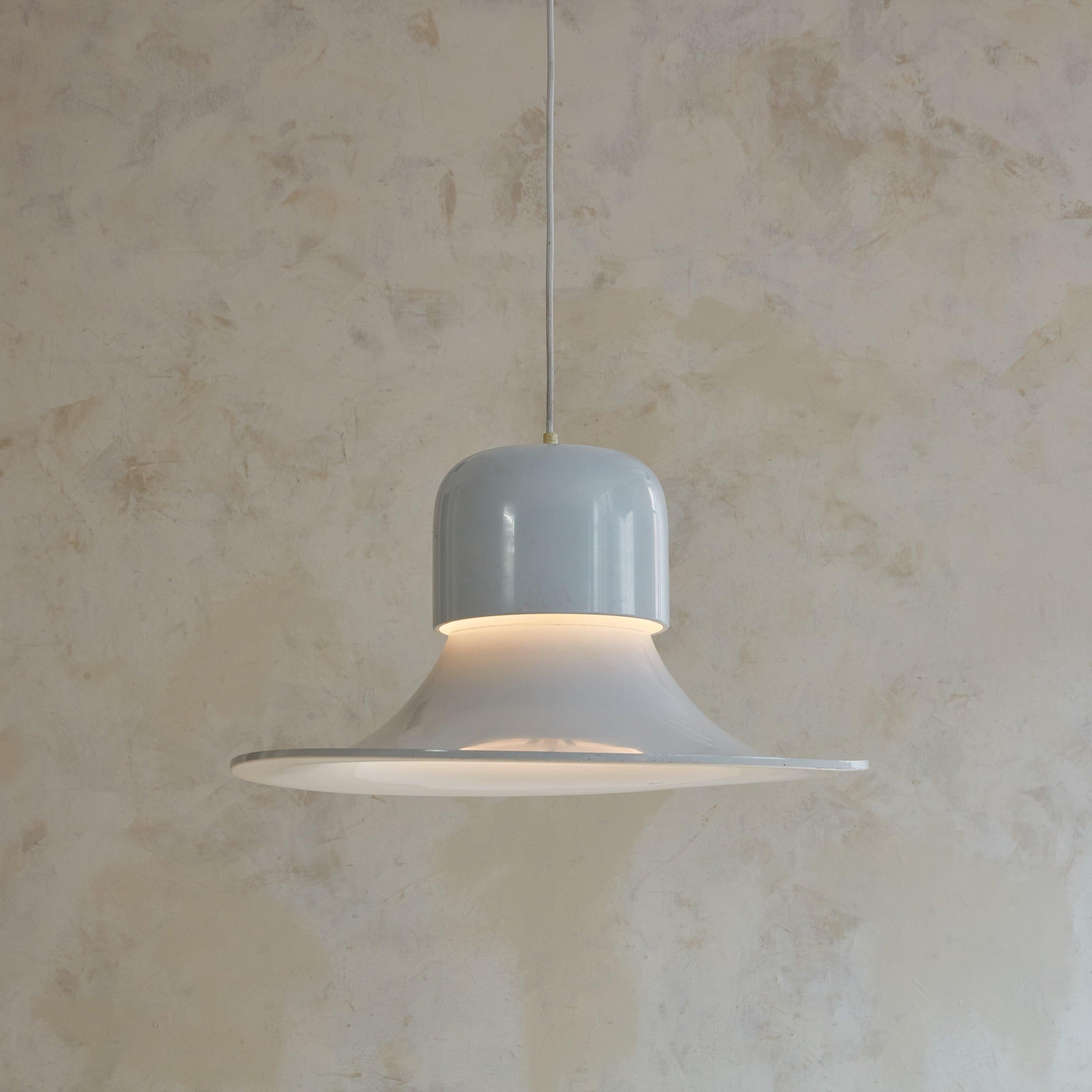 A 1950s Italian pendant light designed by Joe Colombo for Stilnovo. This pendant features a white metal bell-form shade with two tiers and a subtly raised edge. The simple design has a fantastic, large scale, hangs from a white cord, and retains its