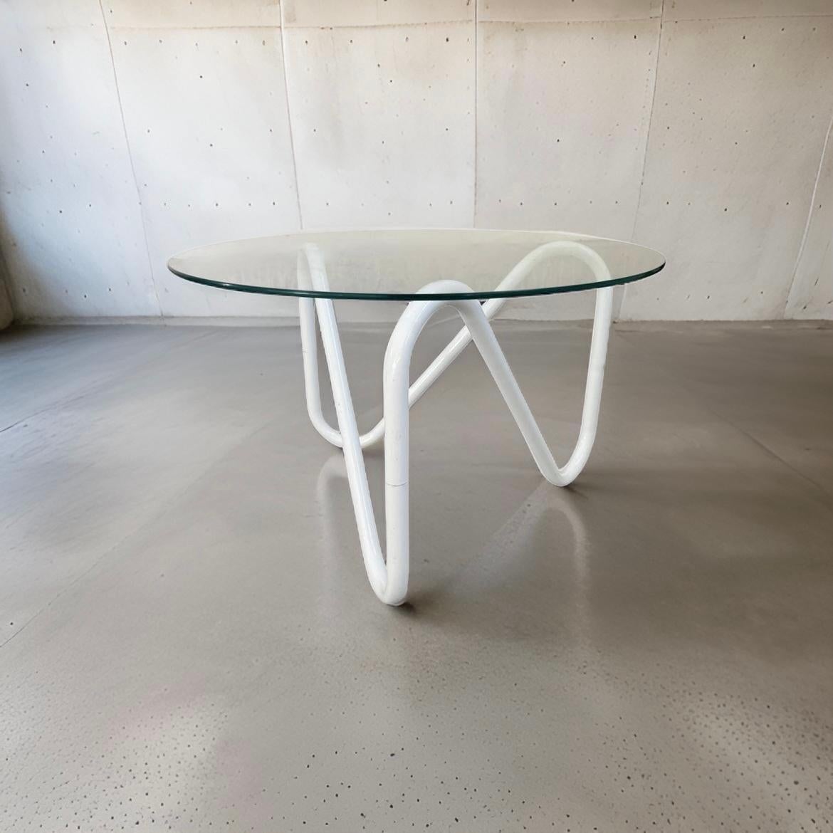 Vintage Tubular Squiggle Metal Coffee Table with Original Glass Top.  Supposedly from the 70s or 80s, the curved metal feels modern and fresh.  It makes a big impact with a minimal silhouette. 

24” Diameter x 14.5” Height